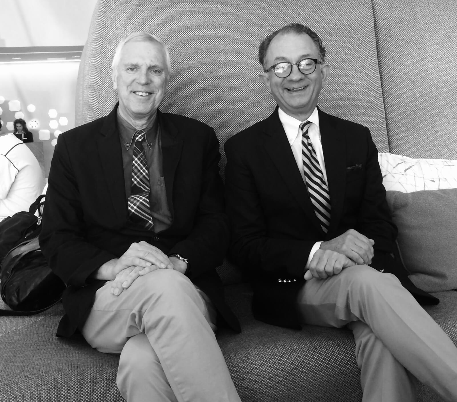 Seated are Stroman collaborators Ken Billington (lighting design) and William Ivey Long (costume design). Both are in blazers and wearing a tie.