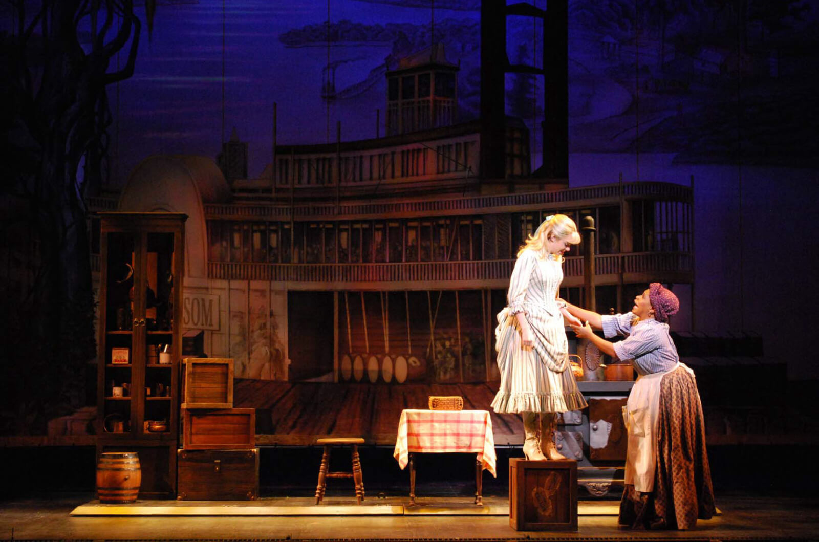 Kaley Ann Vorhees as Magnolia and Bryonha Marie Parham as Queenie in a scene from ShowBoat. Queenie fixes Magnolias hem in Prince of Broadway.