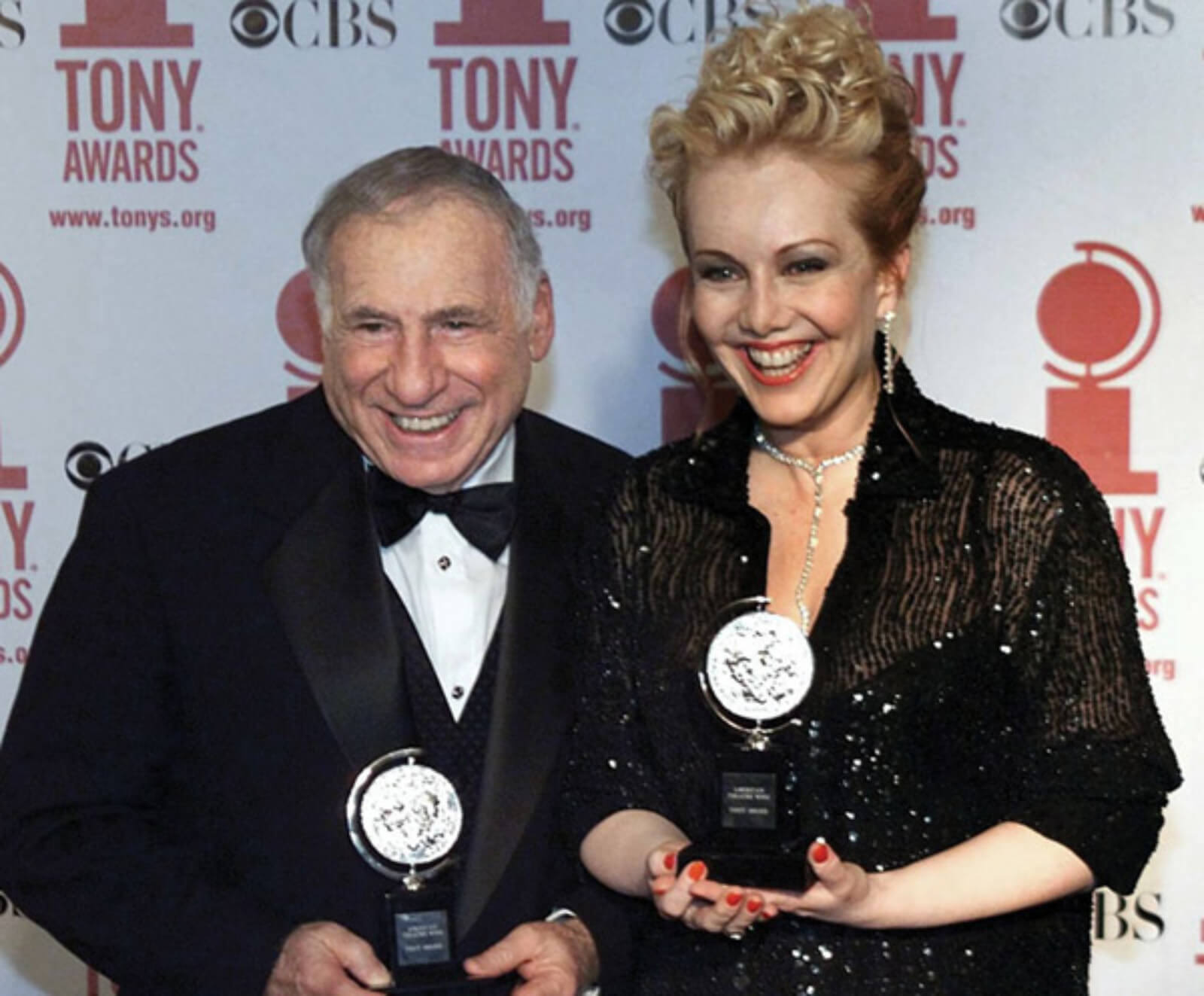 Mel Brooks and Susan Stroman on the red carpet holding Tony Awards, after The Producers received a total of 12 wins.