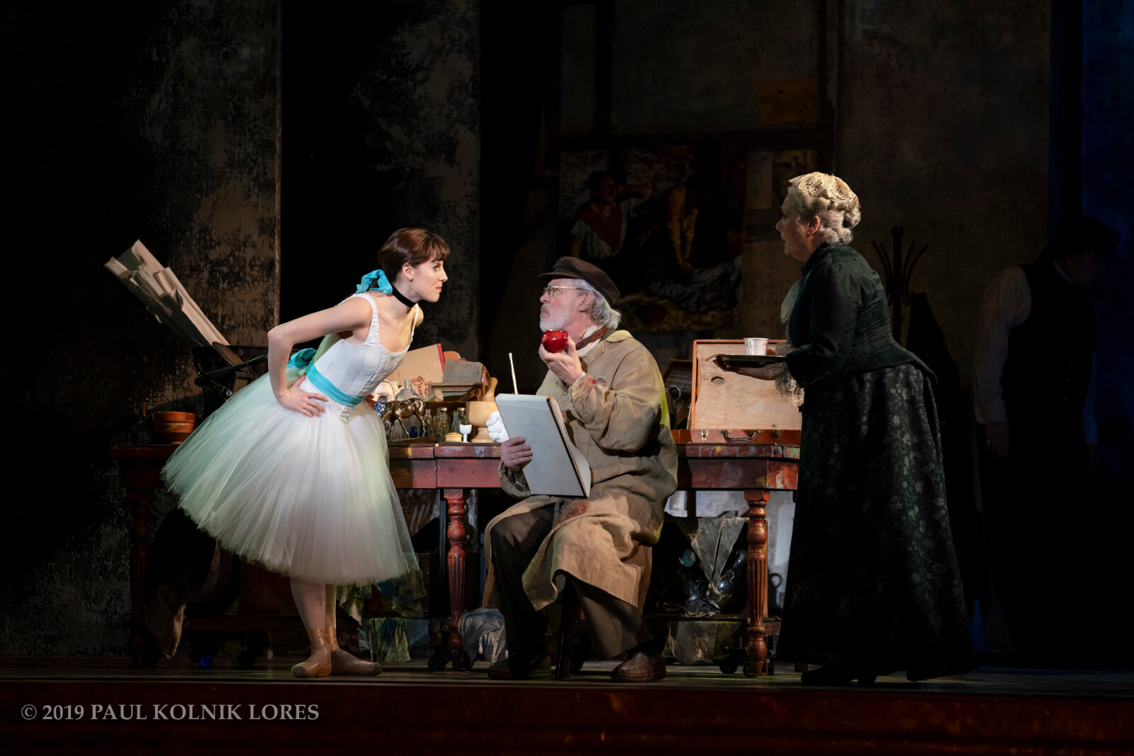 Marie (Tiler Peck) about to steal an apple from Degas (Terrence Mann). Barbara Marineau looks on.