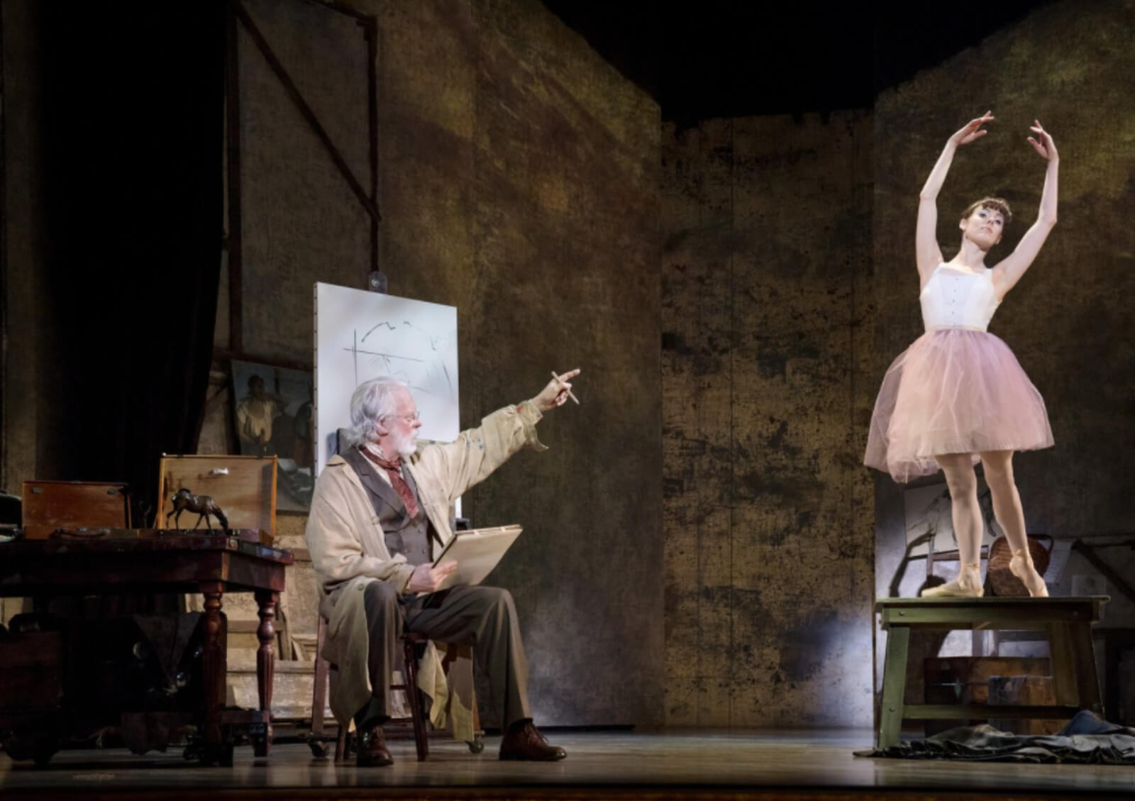 Marie standing on a platform and in pink tutu. She is posing for Degas.