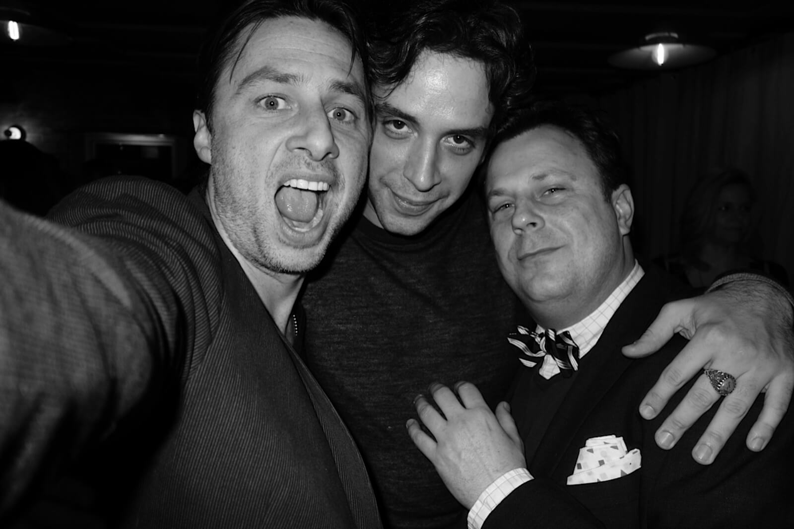 A black and white photo of Zach Braff, Nick Cordero, and Brooks Ashmanskas in street clothes (pictured from left to right).