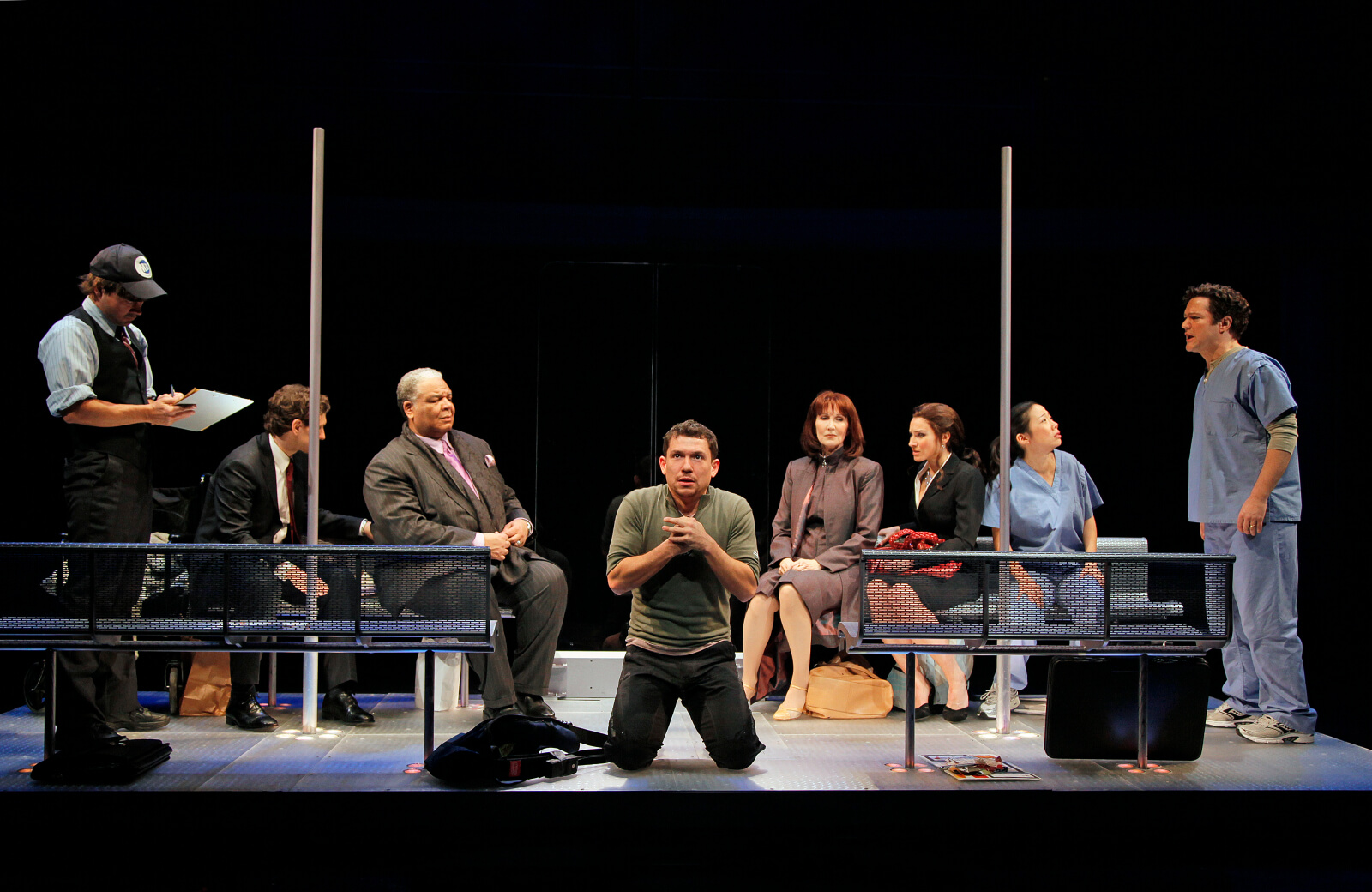 The cast of Happiness in a scene trapped on a subway car.