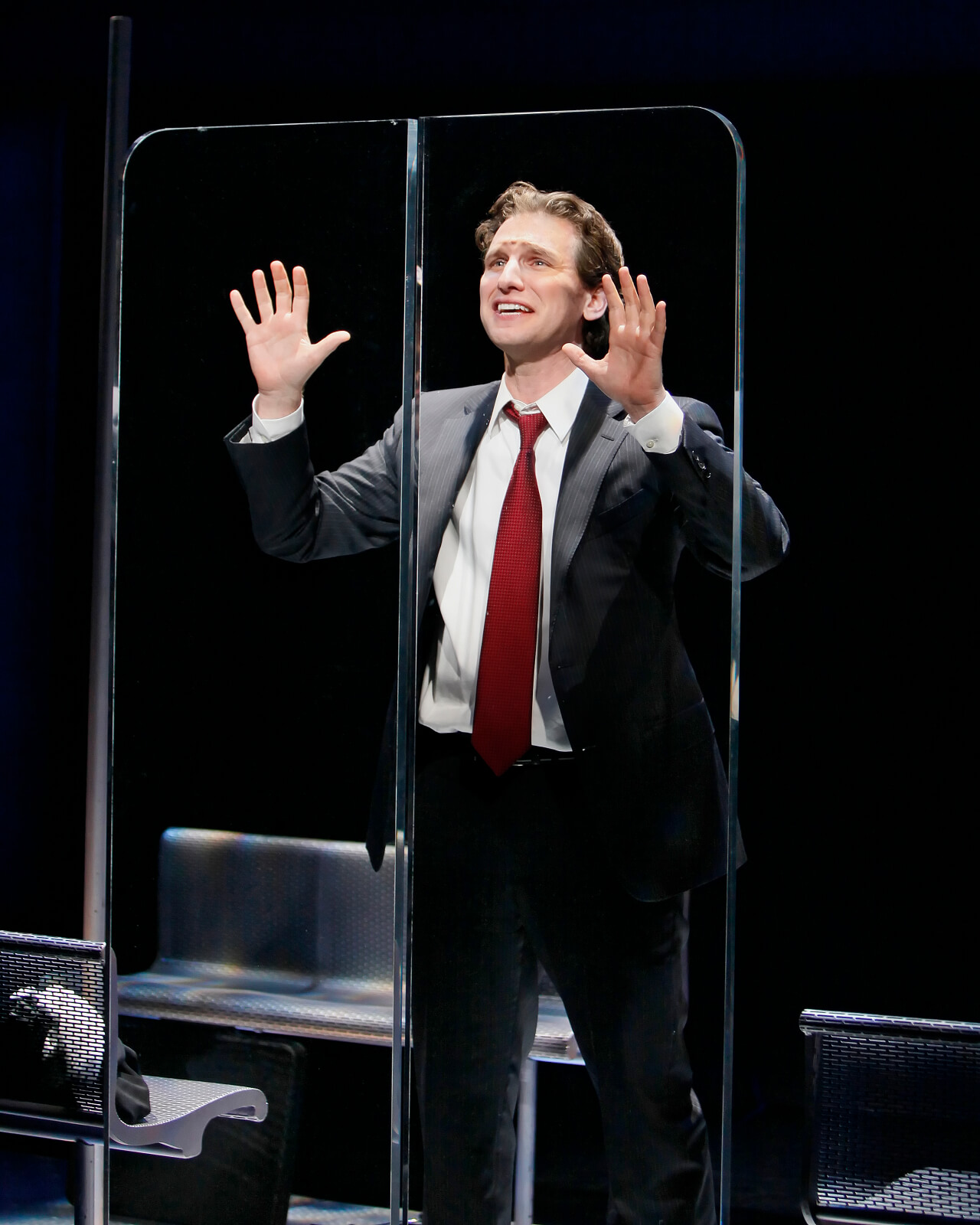 Zack (Sebastian Arcelus) sings "Happiness" he presses his hands on the glass subway doors.