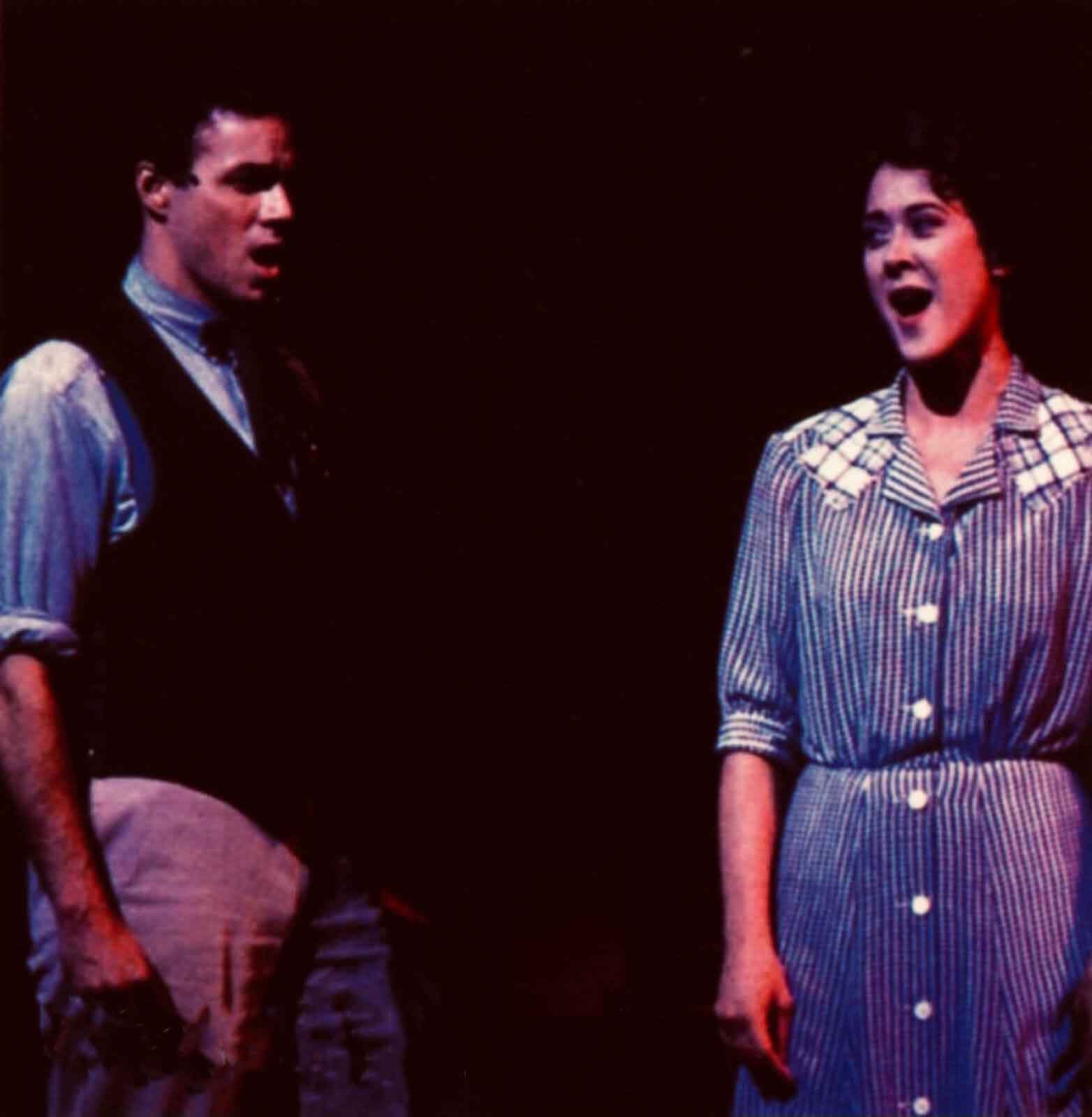 Richard Muenz and Karen Ziemba singing "A Man and a Woman" in 110 in the Shade. He is the sheriff of the town and she wears a blue house dress.