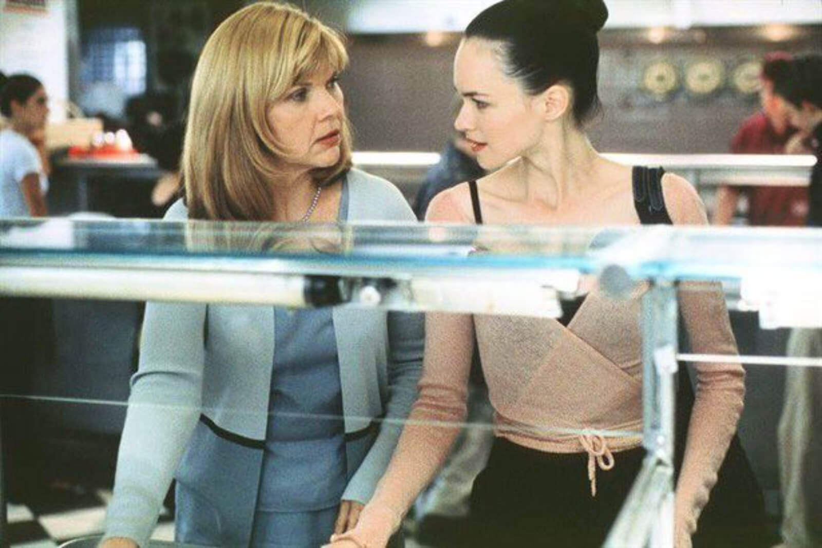 Debra Monk and Susan May Pratt, in a cafeteria line. Mother is looking concerned about her dancer daughter.