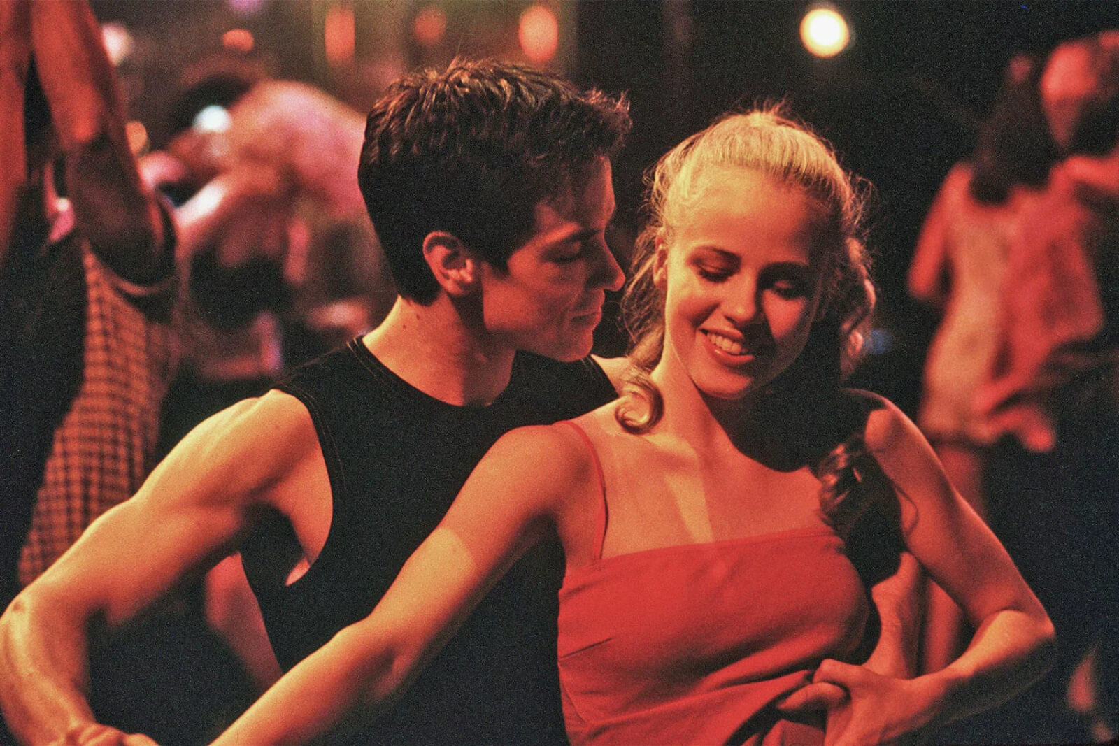Sascha Radetsky and Amanda Schull partnering up. They are dancing closely and at a night club.