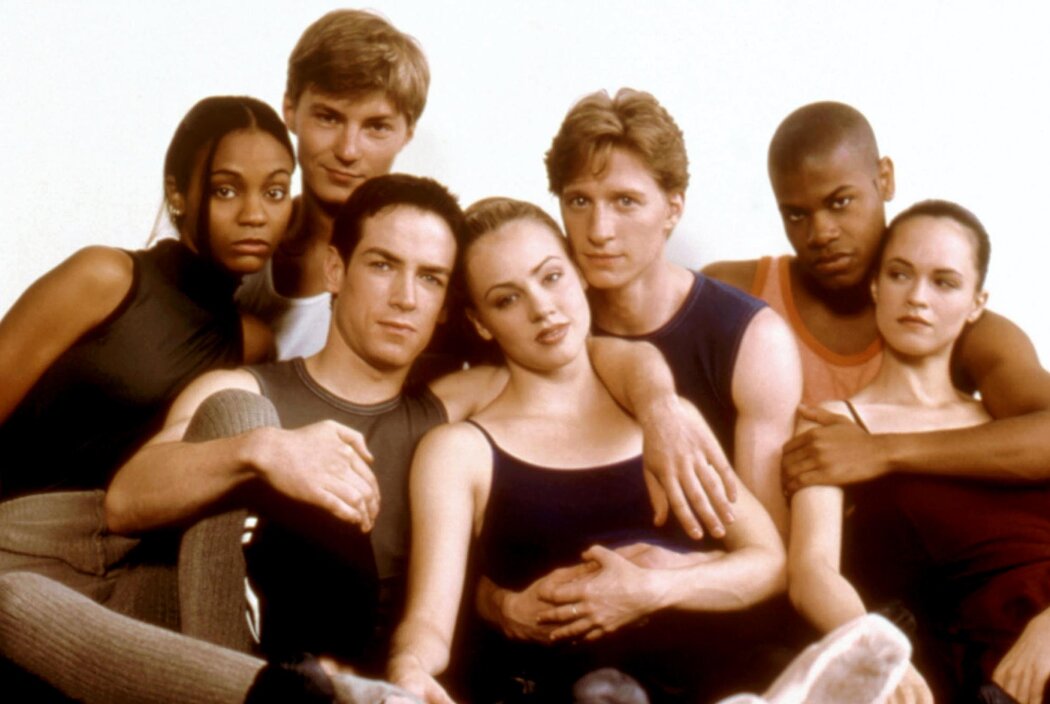 Zoe Saldana, Ilia Kulik, Sascha Radetsky, Amanda Schull, Ethan Stiefel, Shakiem Evans, Susan May Pratt all seen in a clump, wearing dance clothes, and hugging. Photo courtesy of Everett Collection.