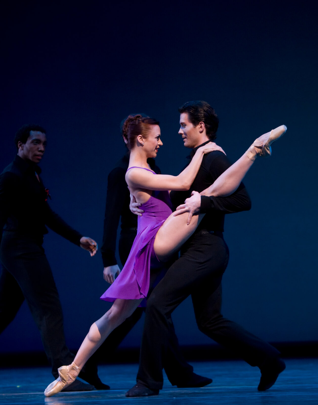 Lesley Rausch and Seth Orza in Take Five... More or Less. He holds her downstage leg in his downstage arm.