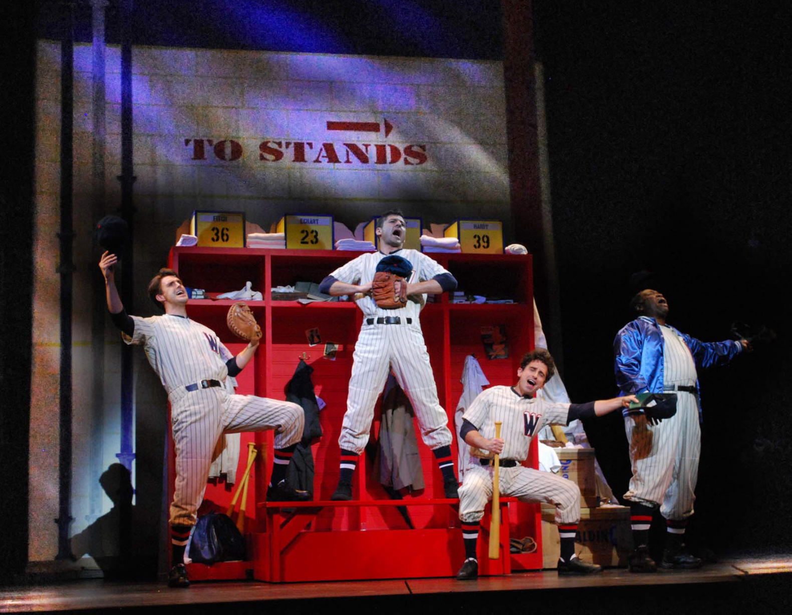 Michael Xavier, Tony Yazbeck, Brandon Uranowitz and Chuck Cooper sing "You've Gotta Have Heart" from Damn Yankees. They are in a baseball locker room dressed in baseball uniforms joyfully singing in Prince of Broadway.