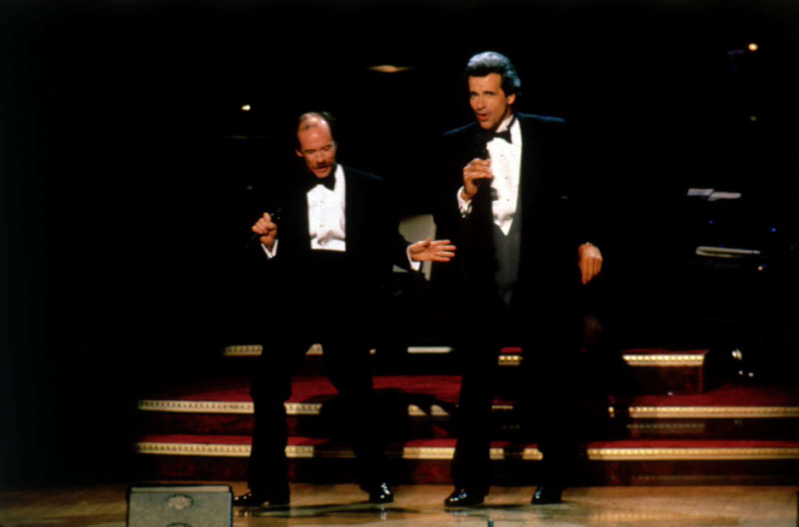 Michael Jeter and James Naughton. Both in suits, singing and dancing.