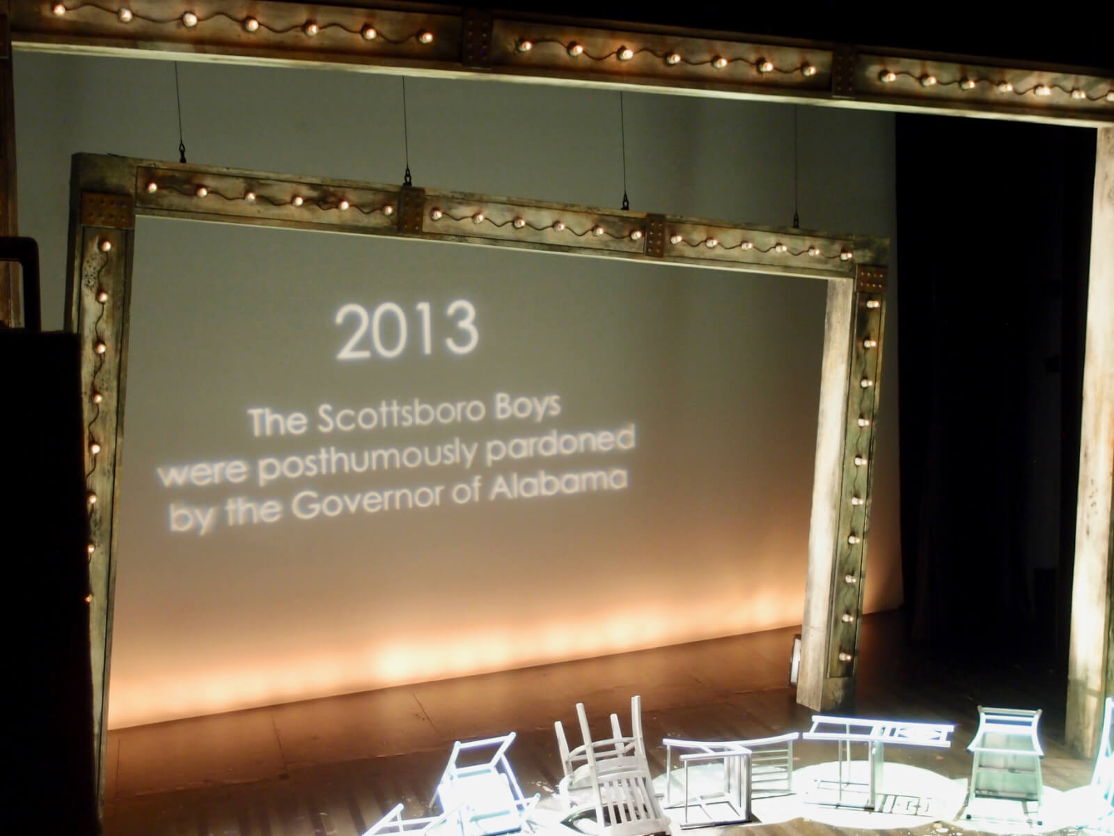 Final projection on the set of The Scottsboro Boys at the Young Vic in London. It reads: "2013: The Scottsboro Boys were posthumously pardoned by the Governor of Alabama."