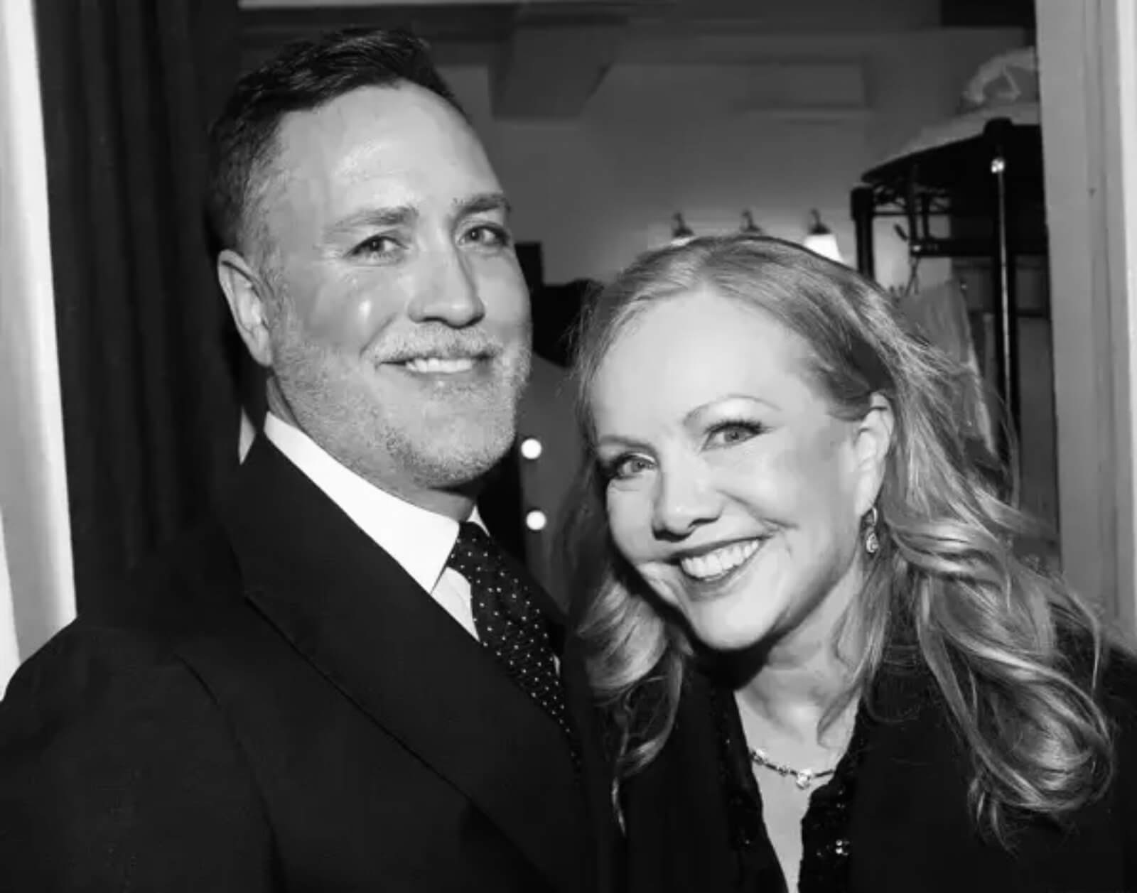 Black and white photo of Scott Bishop and Susan Stroman on Opening Night of New York, New York. He is wearing a black suit and tie. She is in black sequins. They are both sporting open mouth smiles.