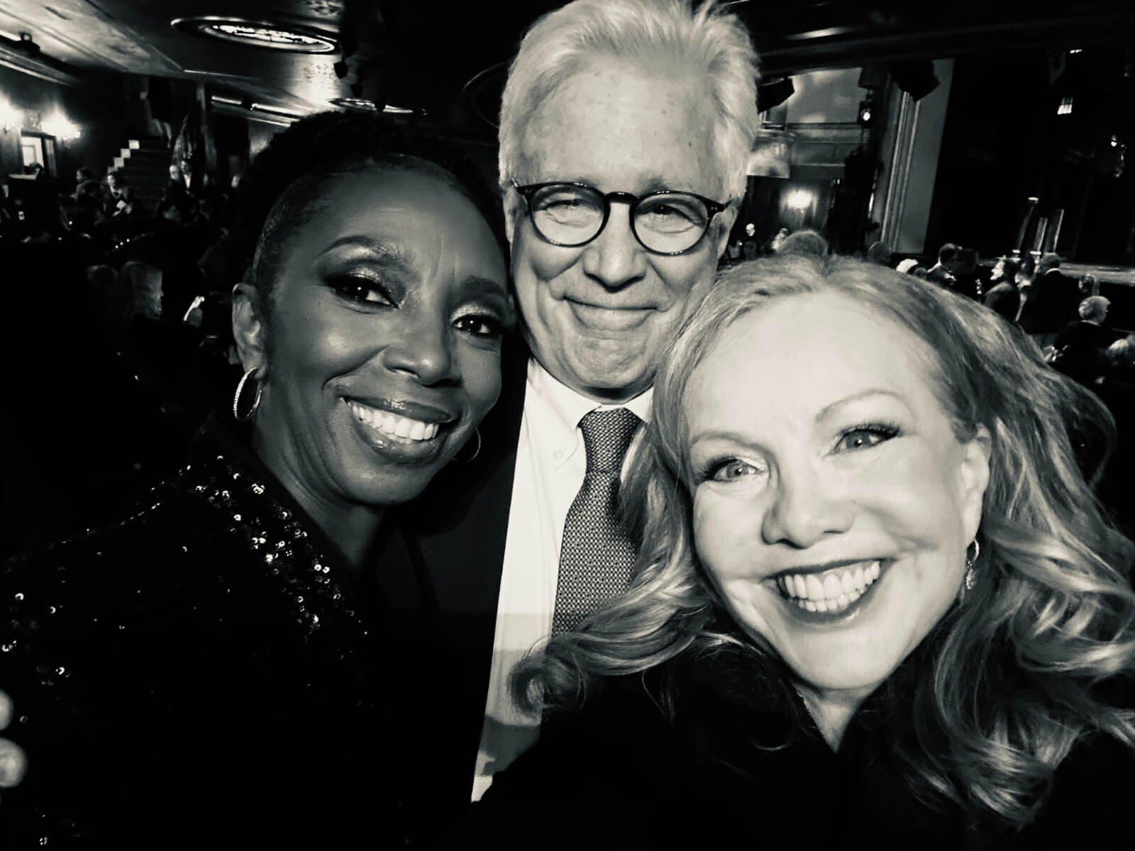 Black and white photo of Sharon Washington, David Thompson and Susan Stroman on Opening Night of New York, New York. They are hugging in elegan attire and sporting open mouth smiles.