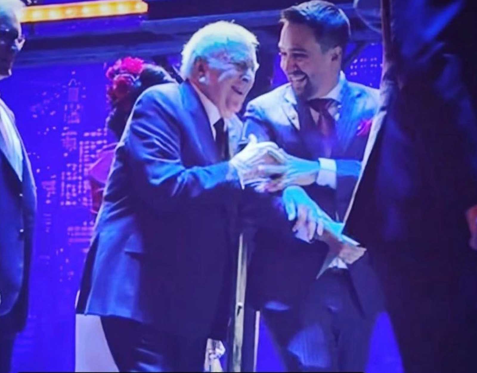 John Kander and Lin-Manuel Miranda on Opening Night. They are exiting the stage smiling, arm in arm. 