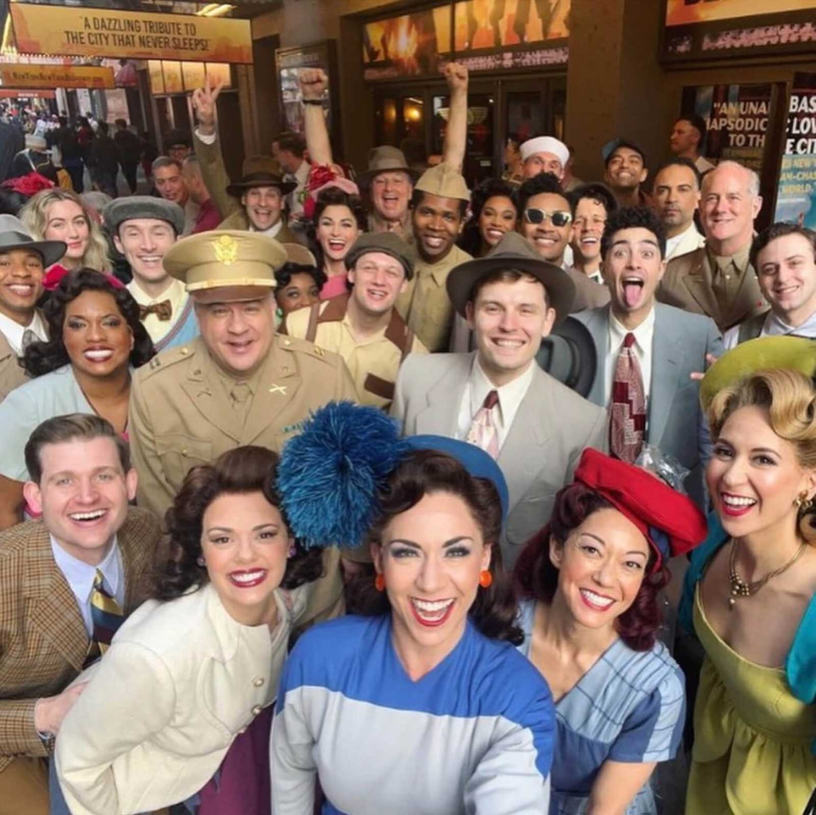 The cast of New York, New York on Tony Award morning. They are in costume and smiling in front of the St. James Theatre.