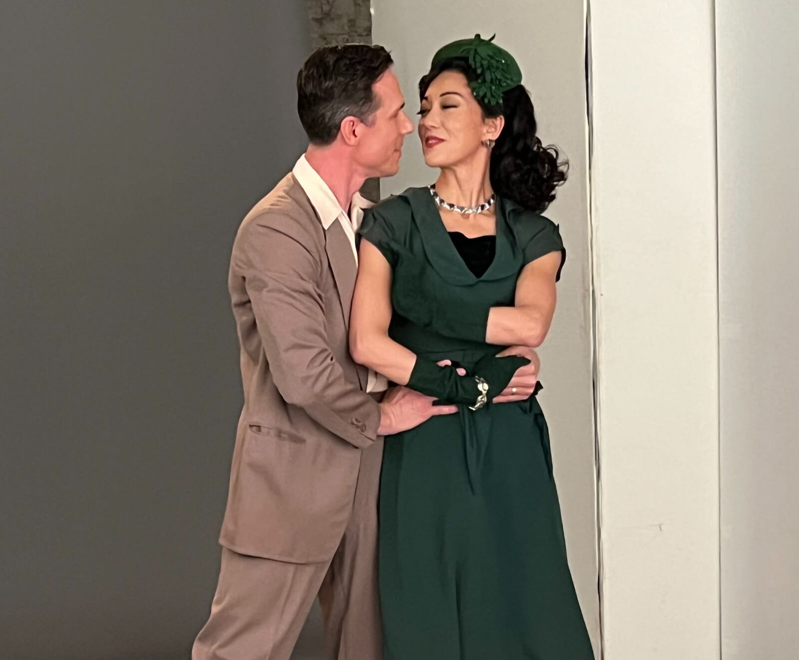 Stephen Hanna and Naomi Kakuk during New York, New York promotional photography with Matt Murphy. They are dancing close and wearing coordinated costumes in green family.