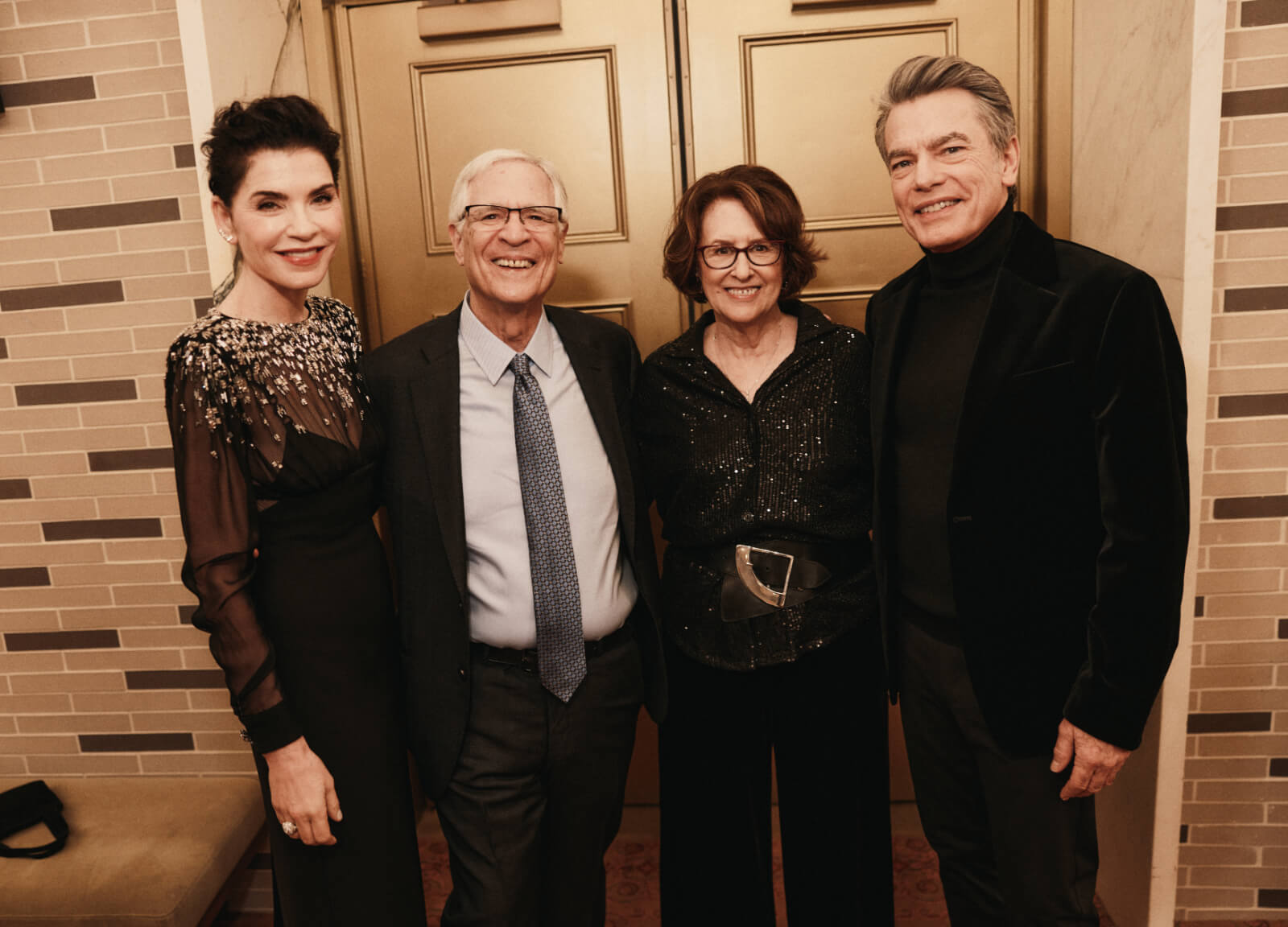Julianna Margulies, Peter Rutter, Delia Ephron, and Peter Gallagher on opening night of Left on Tenth. They are standing outside the theatre in formal black tie attire.
