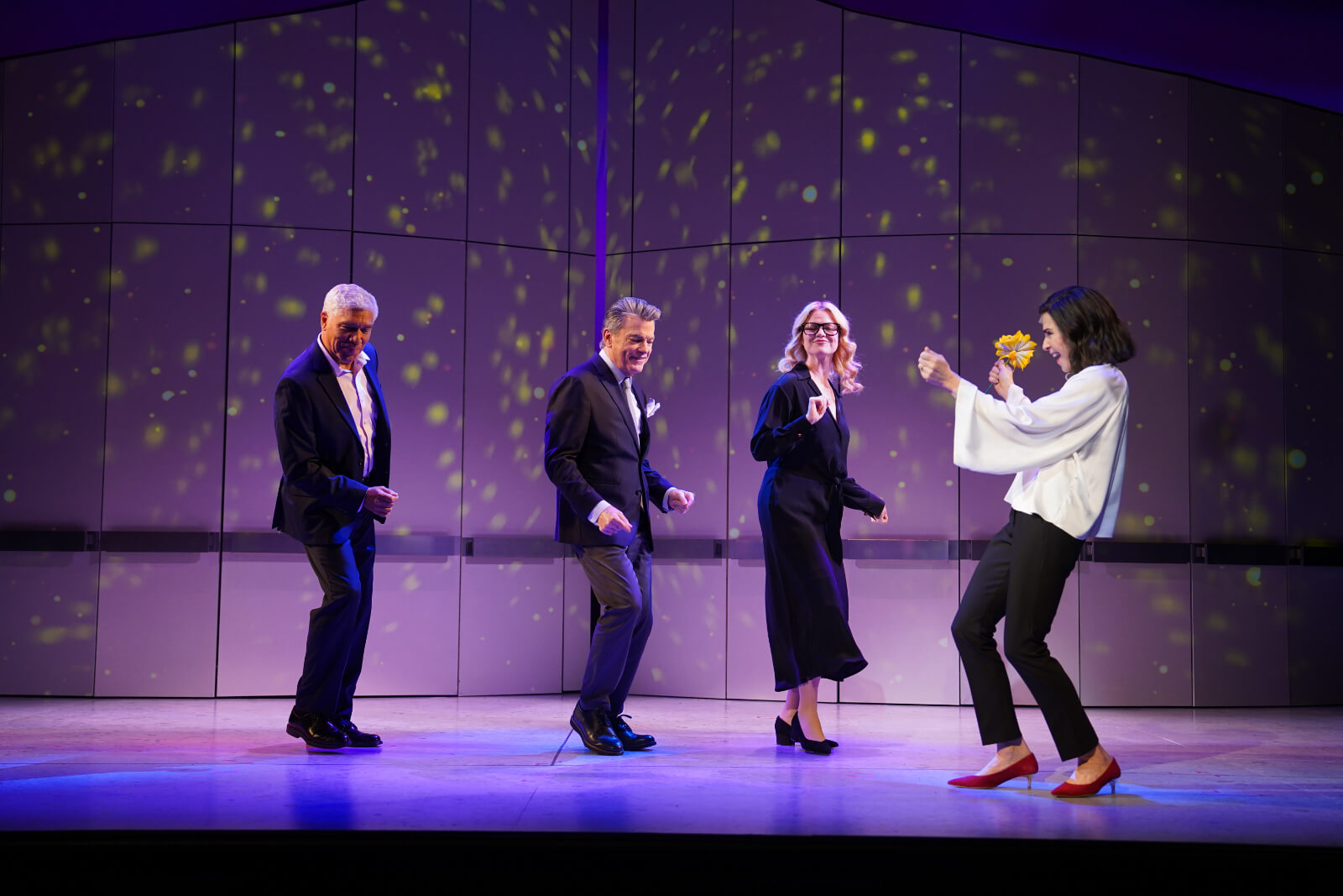 Peter Francis James, Peter Gallagher, Kate MacCluggage all upstage dancing while Julianna Margulies is downstage dancing with wedding bouquet in her hands.