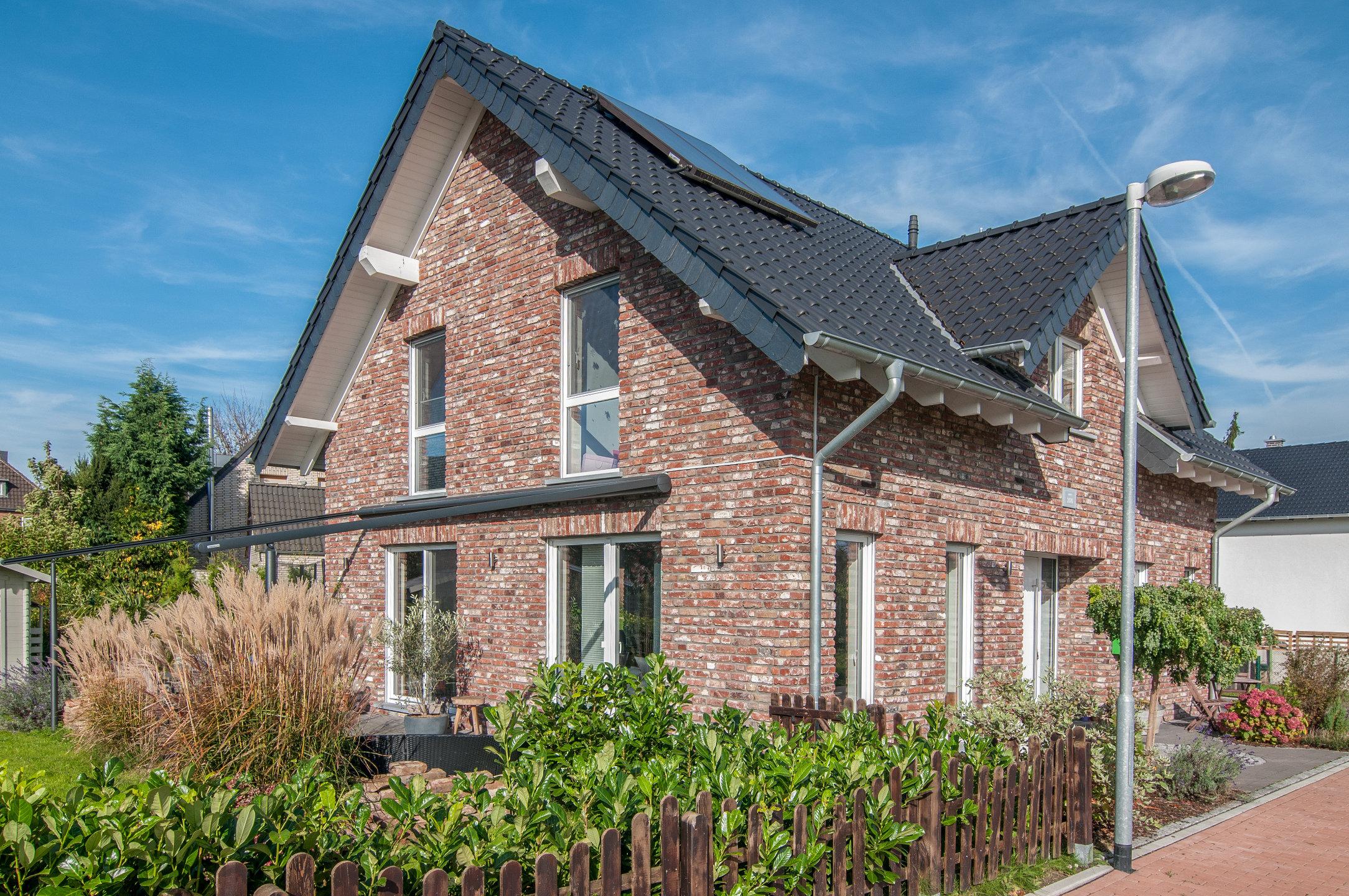 Giebelseite mit Klinkerfassade und Gartenhaus