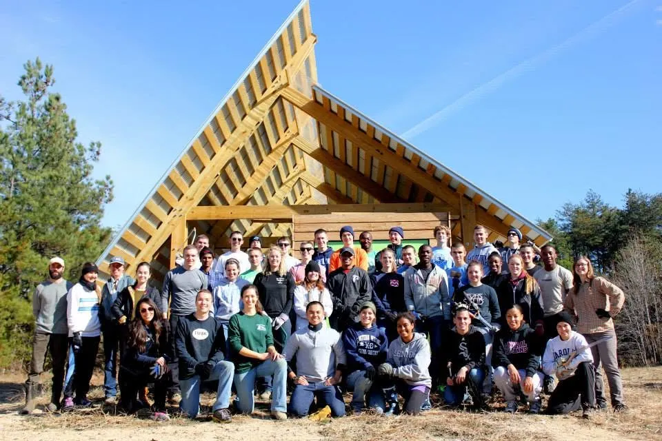 A large group gathered at the farm's timber-framed pavilion