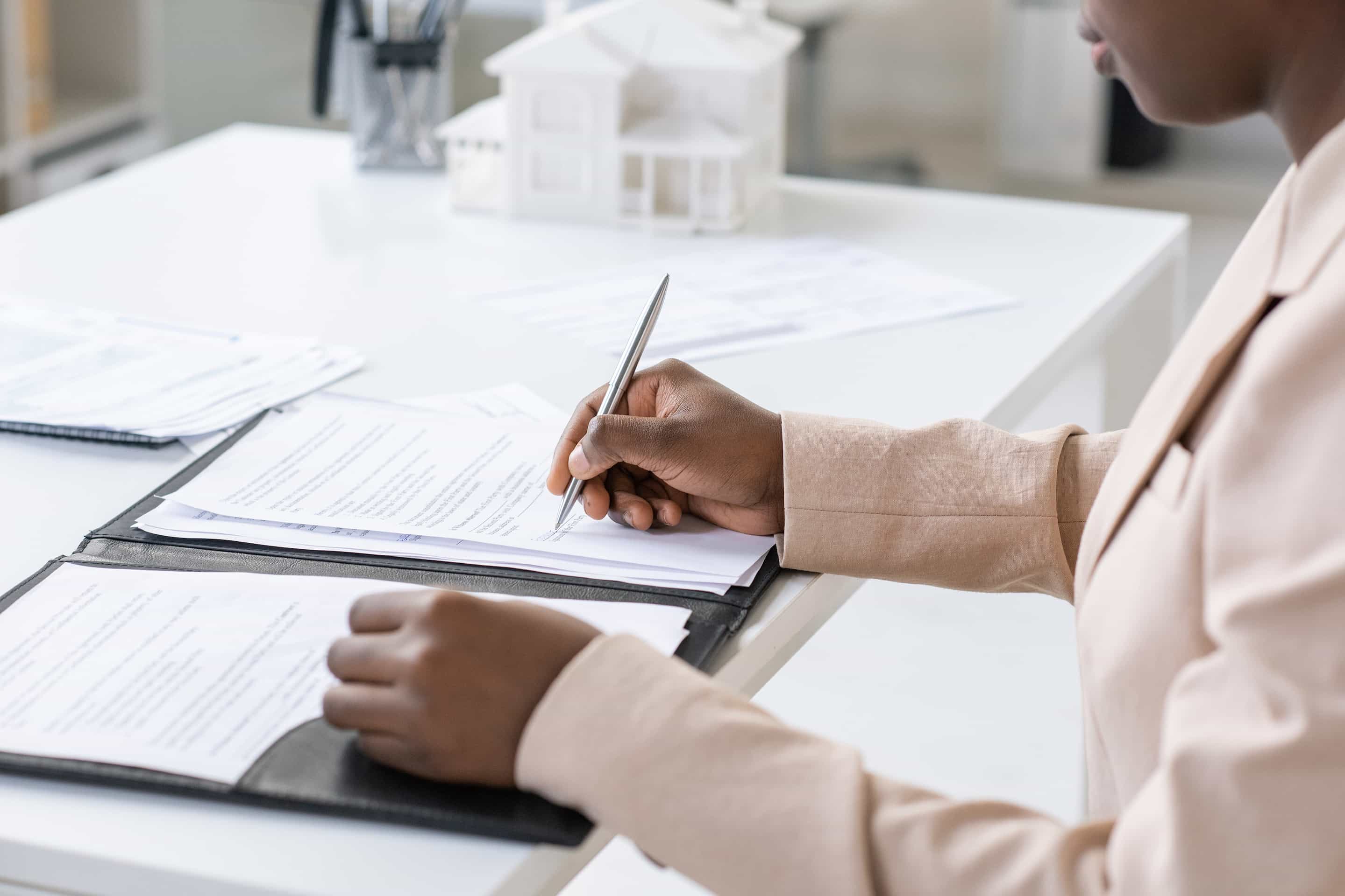 Young woman signing legal documents