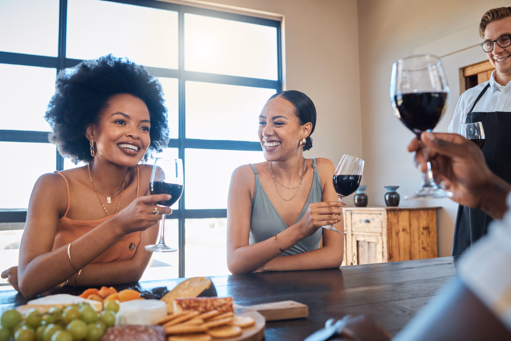 Women chatting with wine glasses
