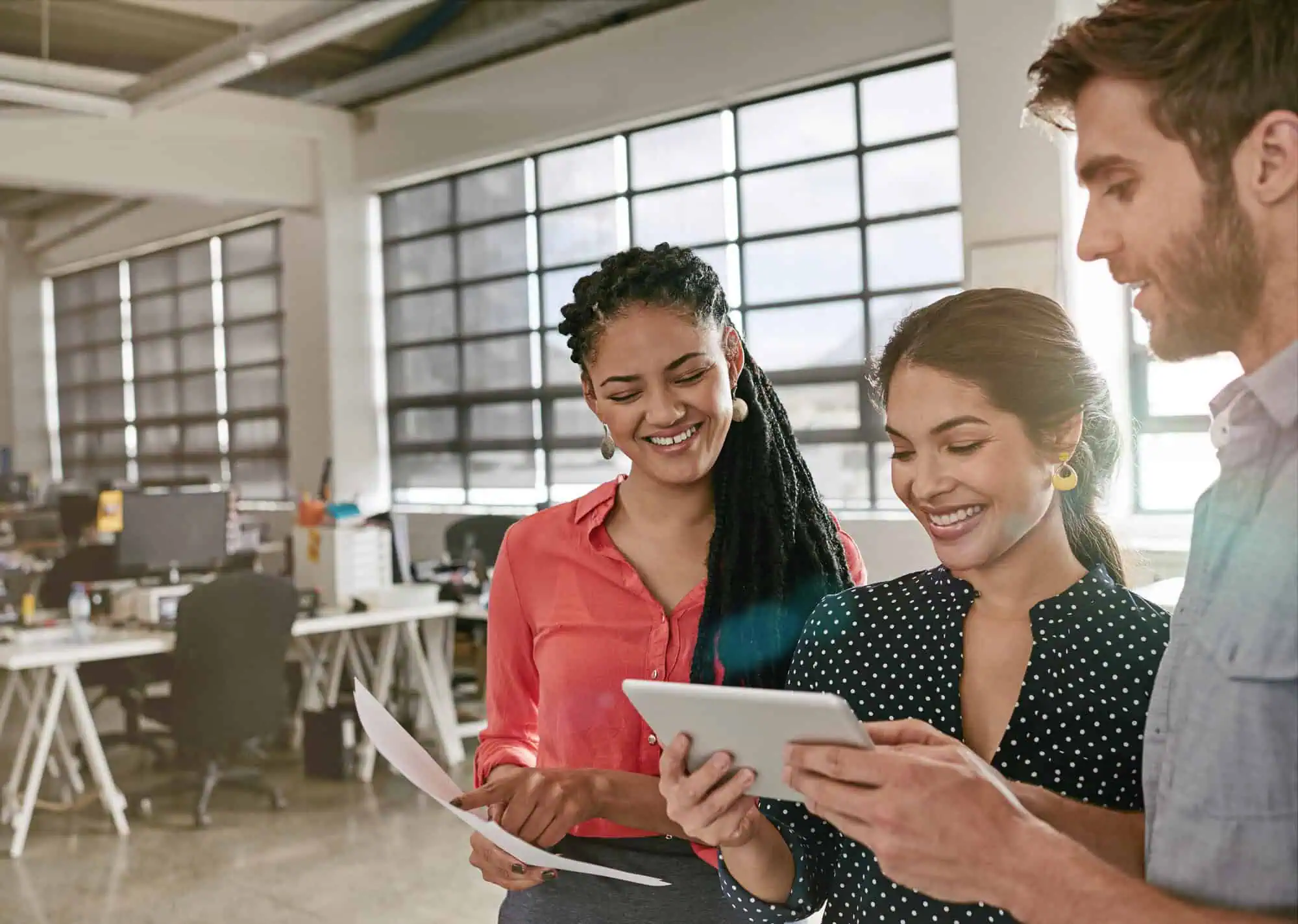 woman training new employees with tablet