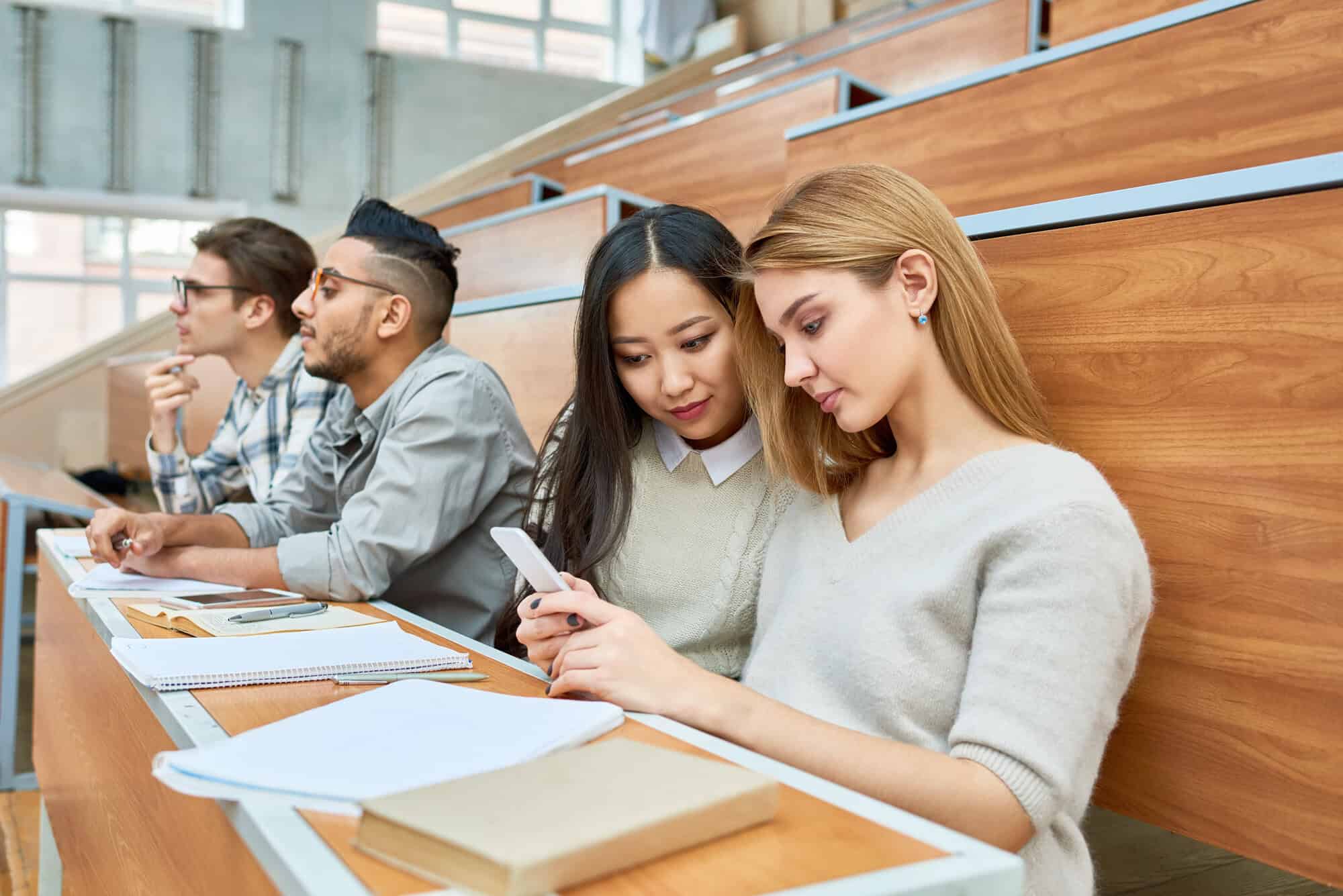 students in lecture room on their devices