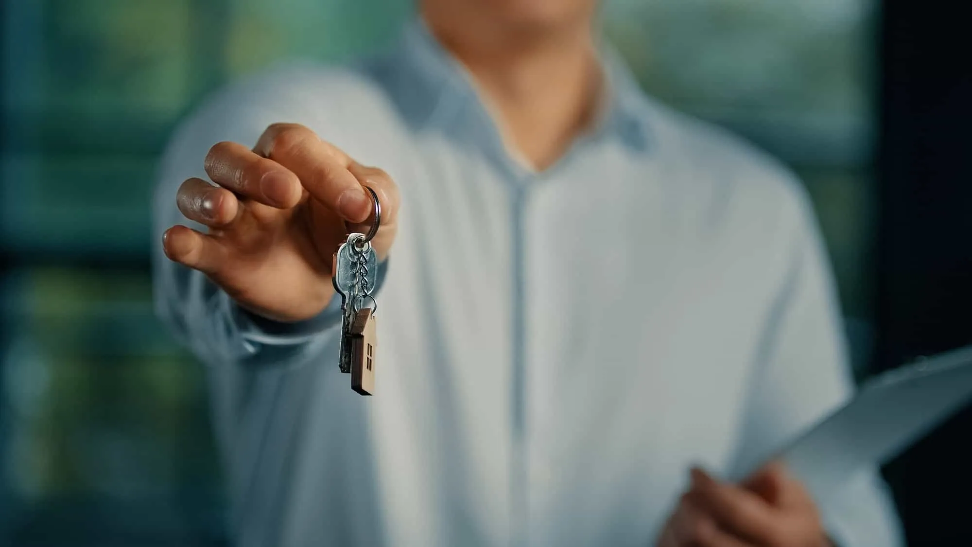 real estate agent handing keys to user