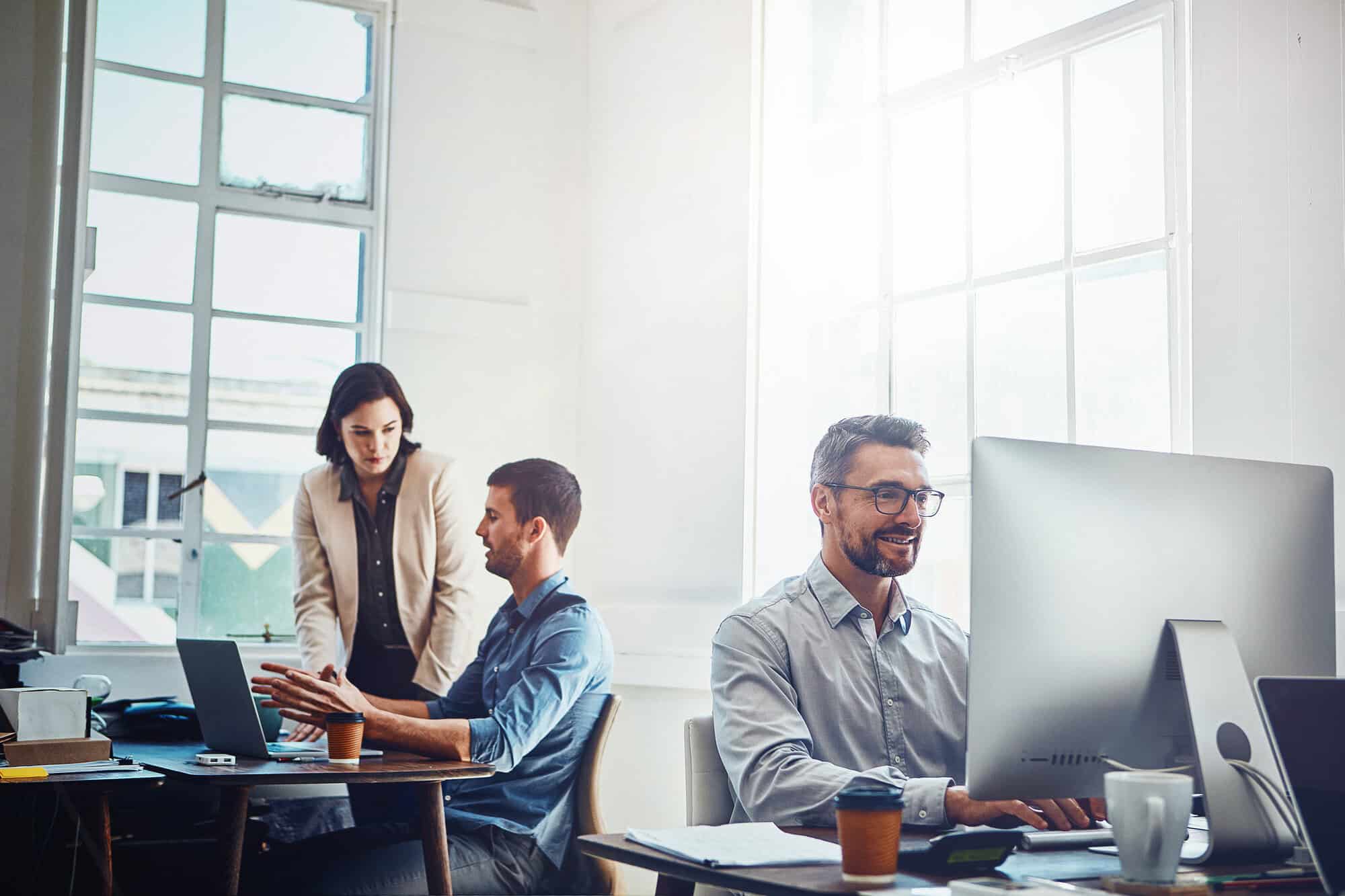 workers at desk in open office