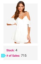 Woman wearing white off-shoulder dress with crisscross straps posing against white background.
