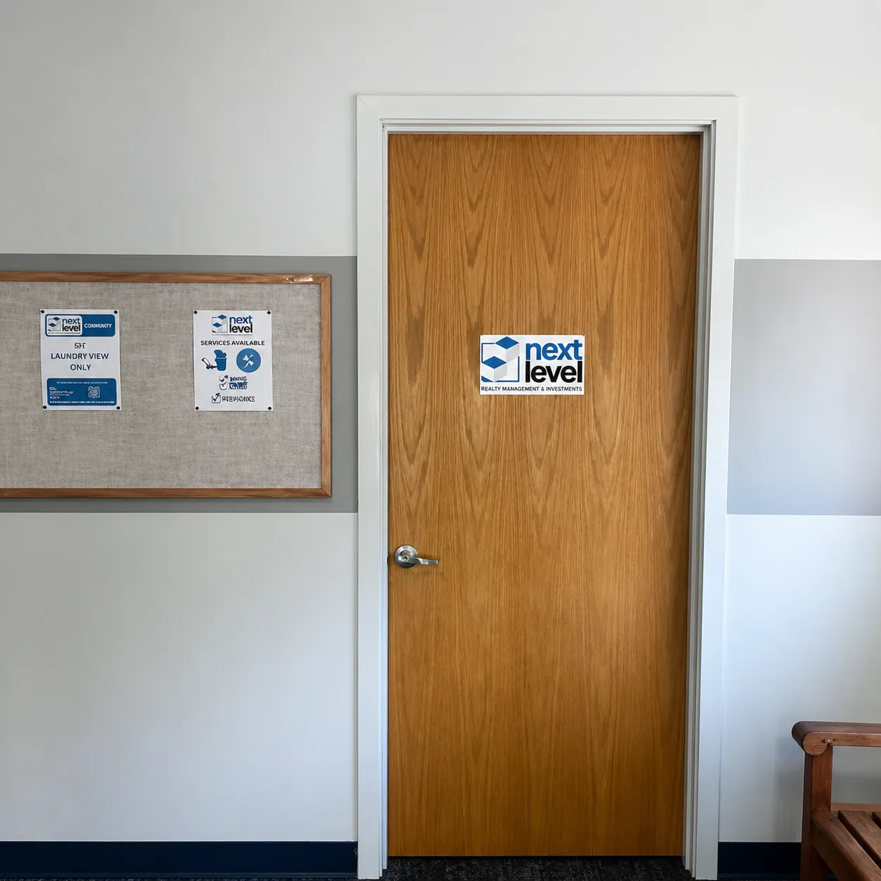 Wooden door with Next Level Realty Management & Investments sign and bulletin board with notices on left wall.