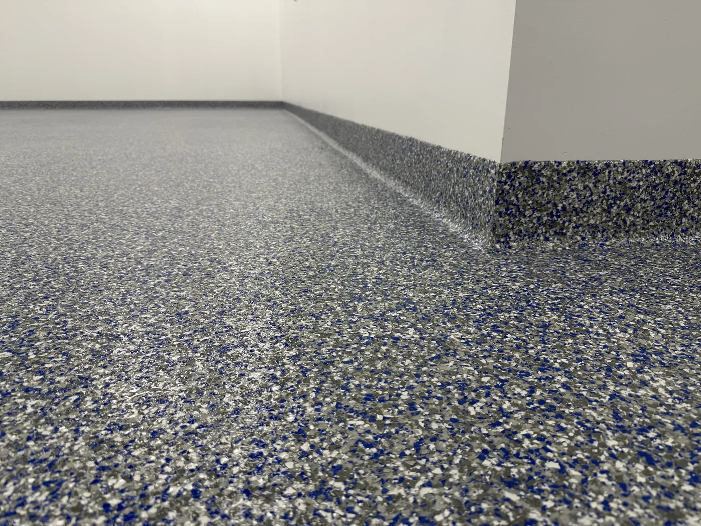 Pharmaceutical manufacturing clean room floor with seamless flake epoxy and integral cove base