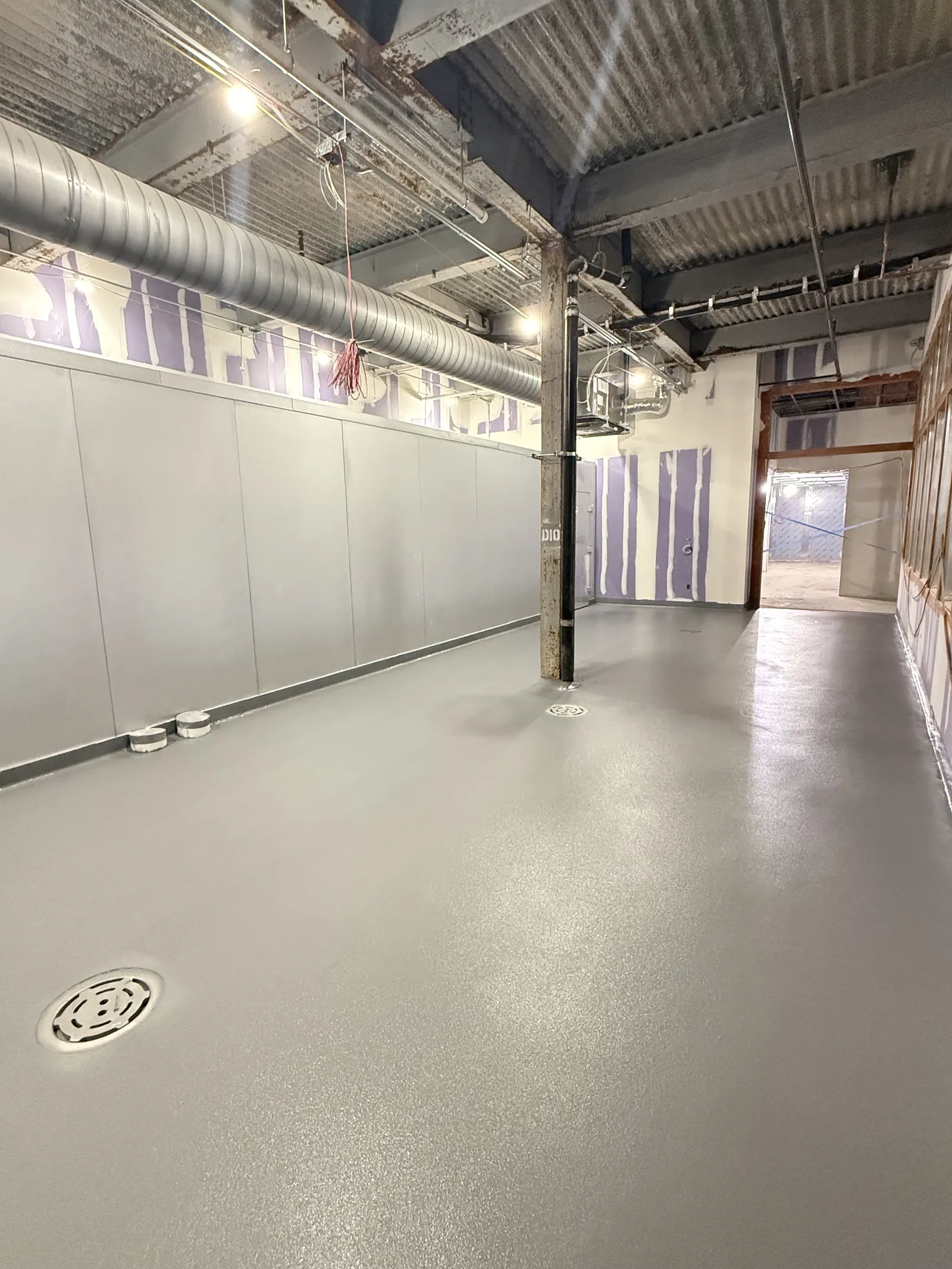 Textured gray wash-down floor coating with floor drain