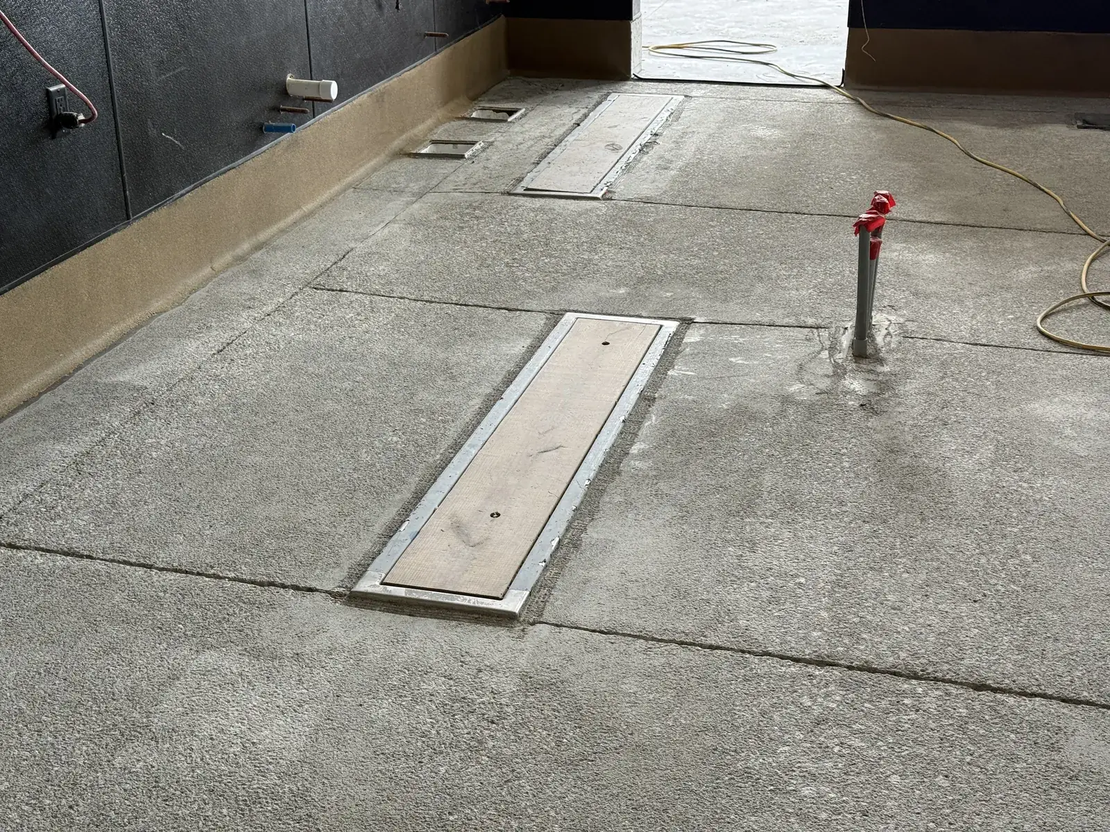 Well-prepared concrete kitchen floor with trench drain, ready for urethane cement