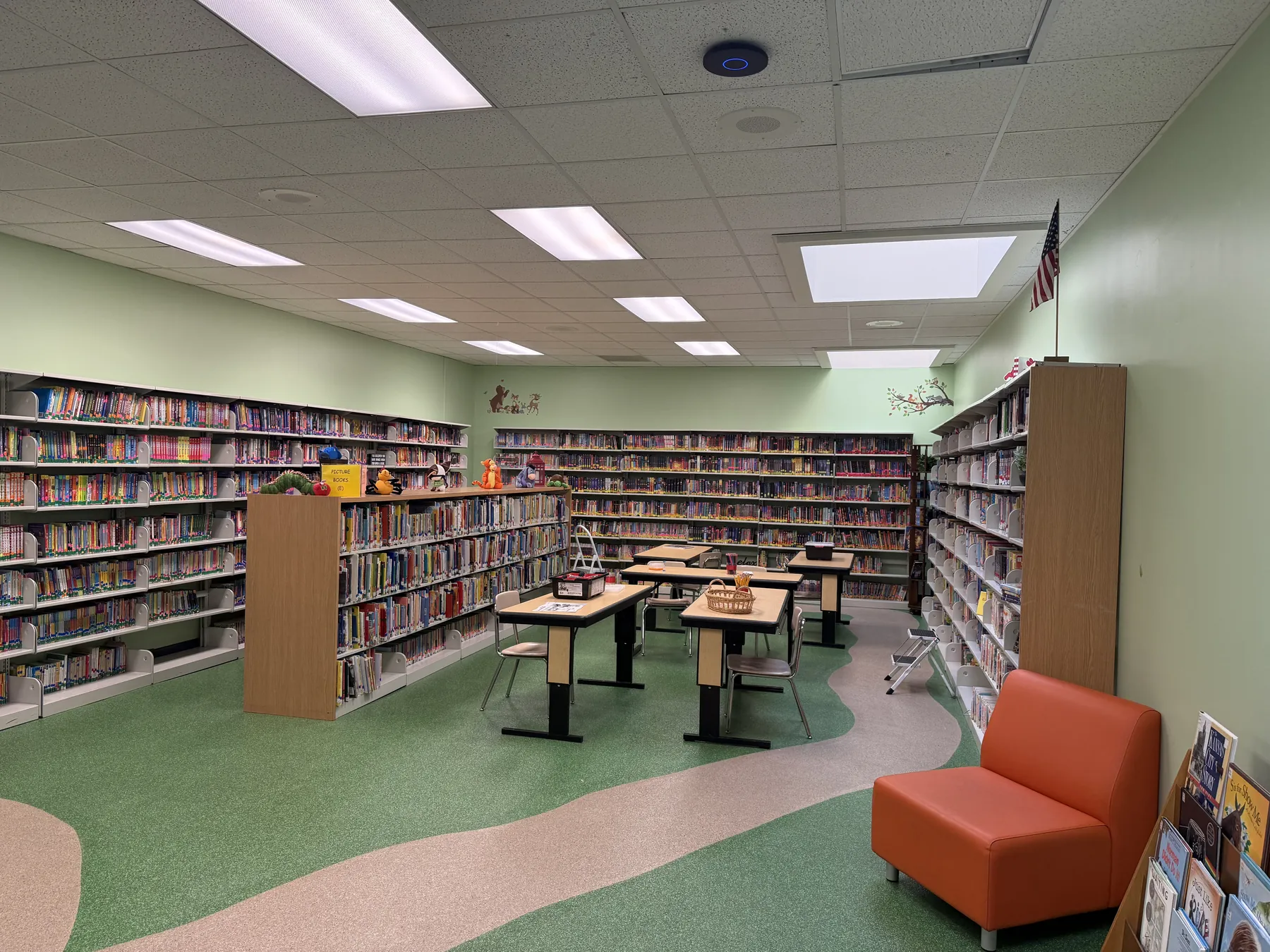Finished school library with green decorative flake epoxy floor and winding tan path