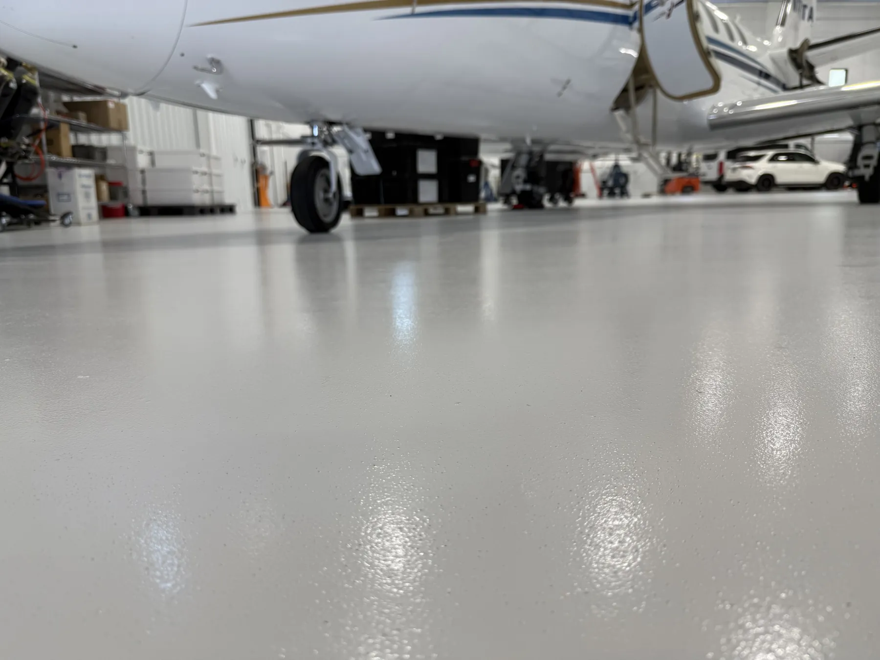 Jet nose over a seamless gray epoxy hangar floor installed by GroCo