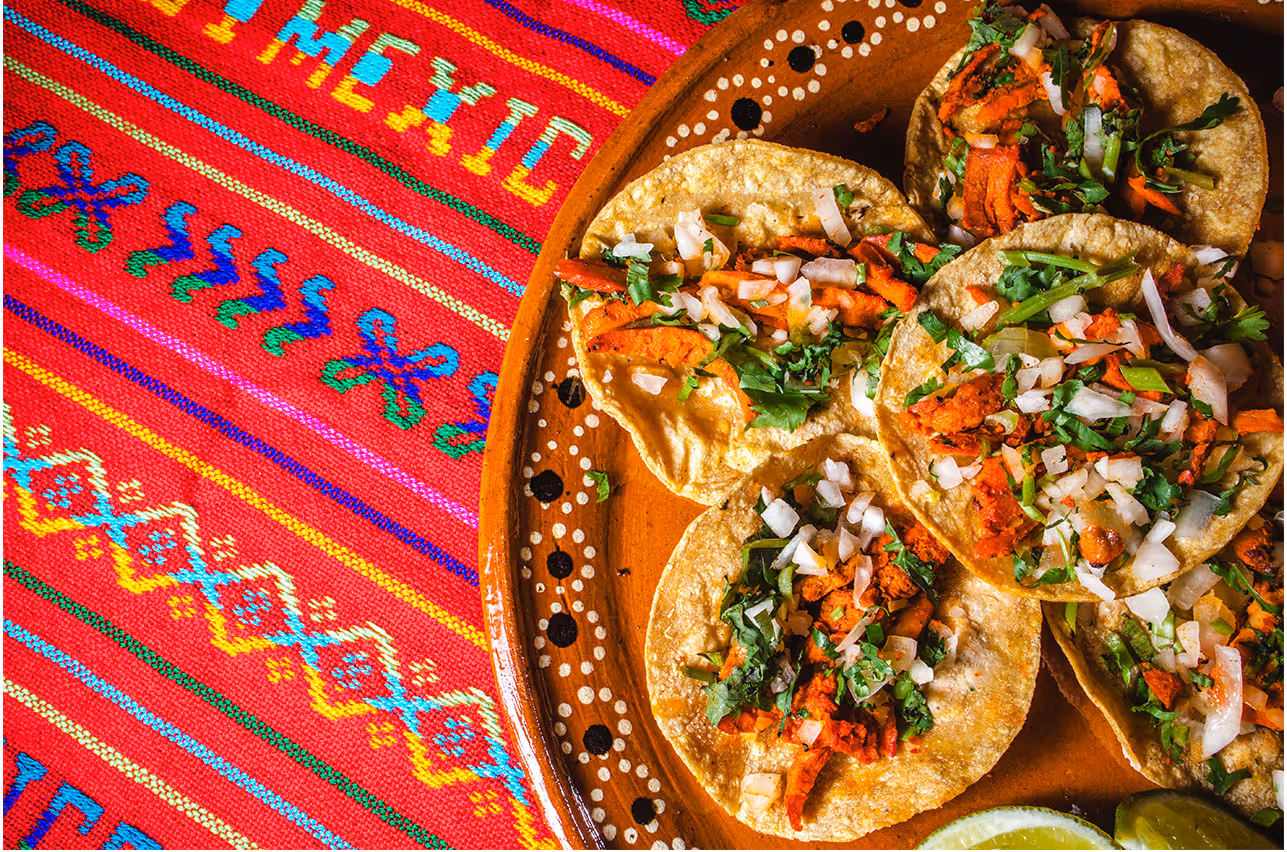 A plate with five street tacos
