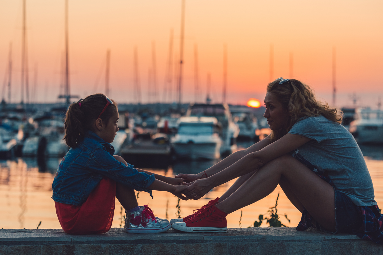 Mother and daughter spending time together at a marina after divorce