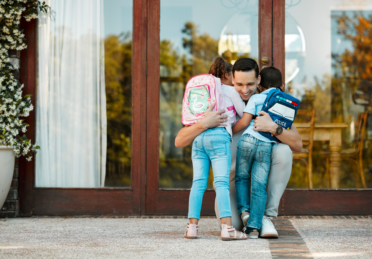 Parent greeting their child at the door during a custody exchange
