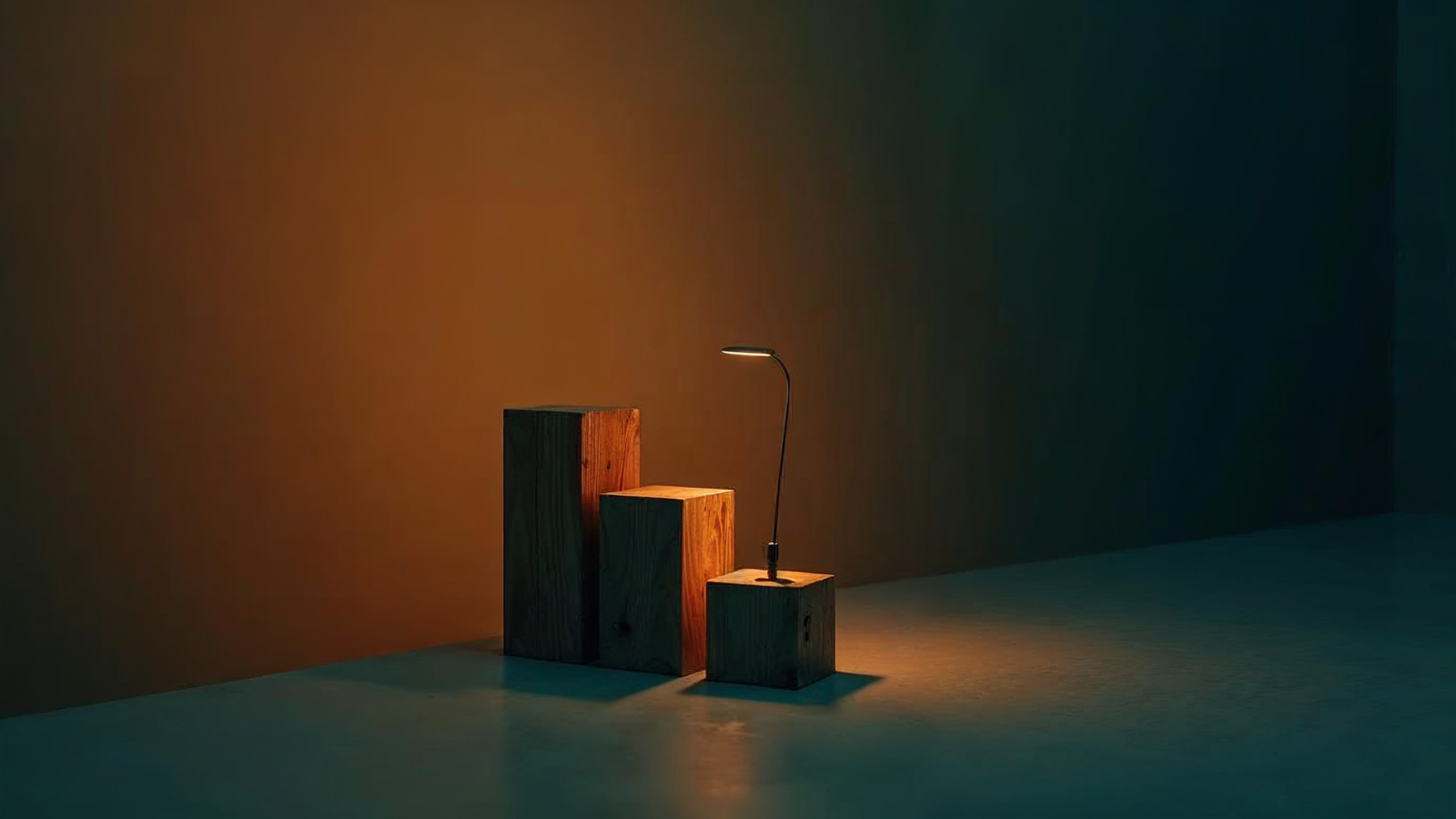 Single asphalt shingle standing beside rising wooden blocks lit in amber
