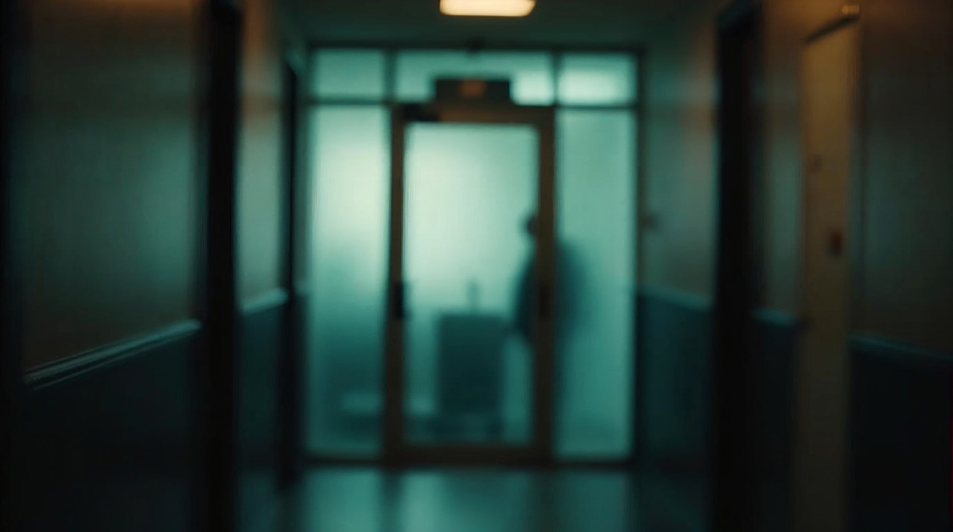 Frosted-glass office door of a small accounting practice seen from the corridor at dawn