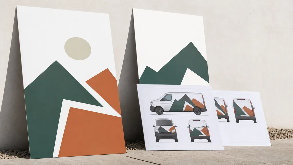 Editorial photograph of printed logo boards and vehicle wrap proofs propped against a pale studio wall in bright dry Arizona daylight