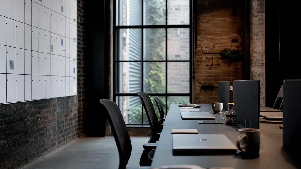 Photograph of an empty Melbourne marketing agency workspace with desks, closed laptops and a wall planner in natural light