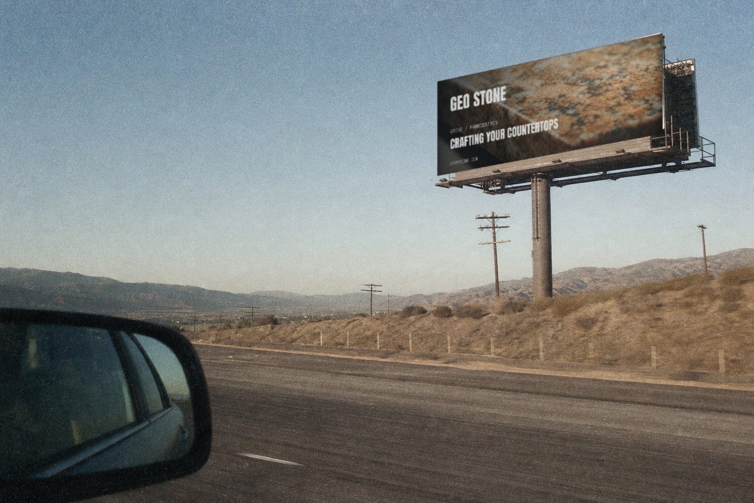 Geo Stone campaign render — highway billboard