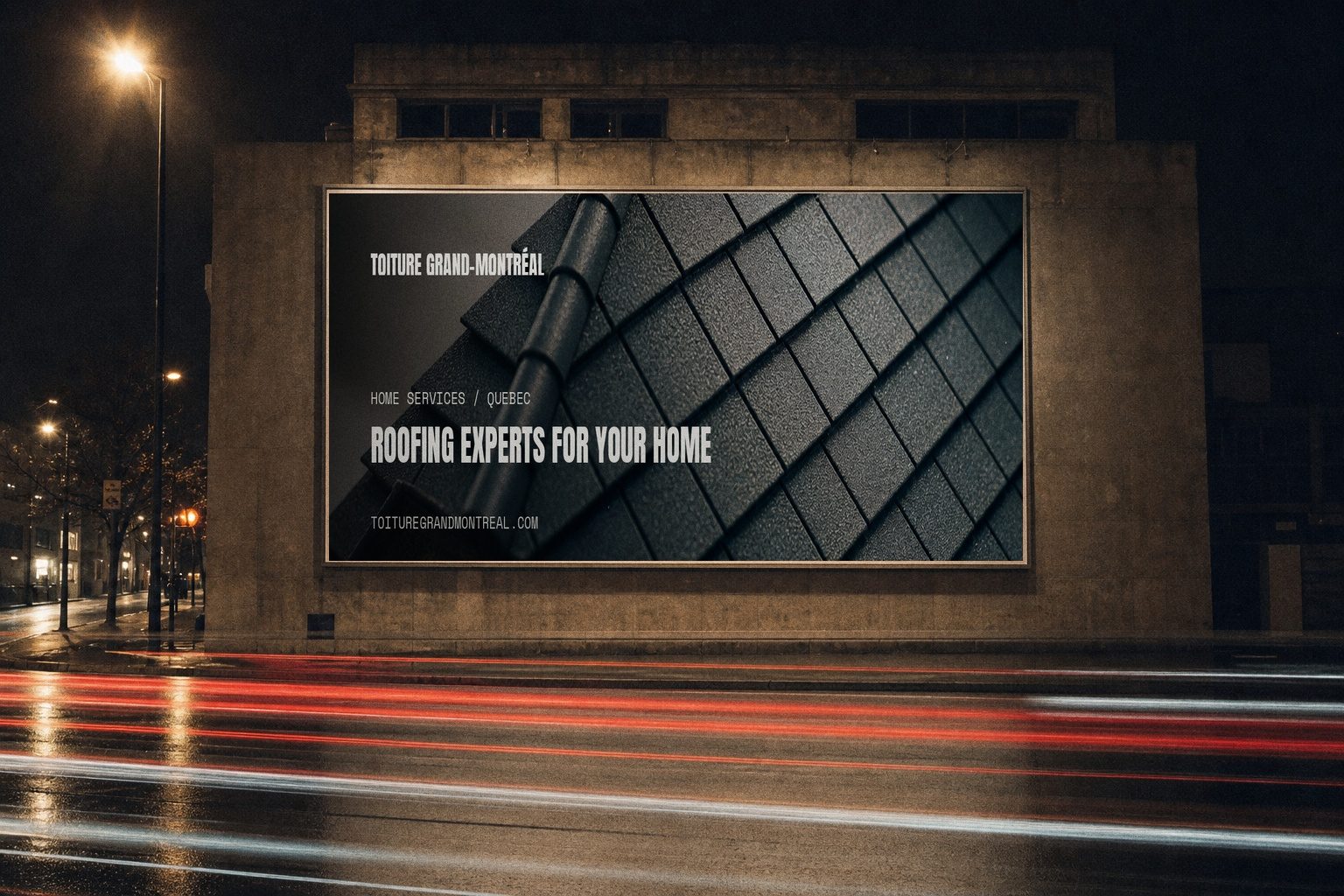 Toiture Grand-Montréal campaign billboard lit at night