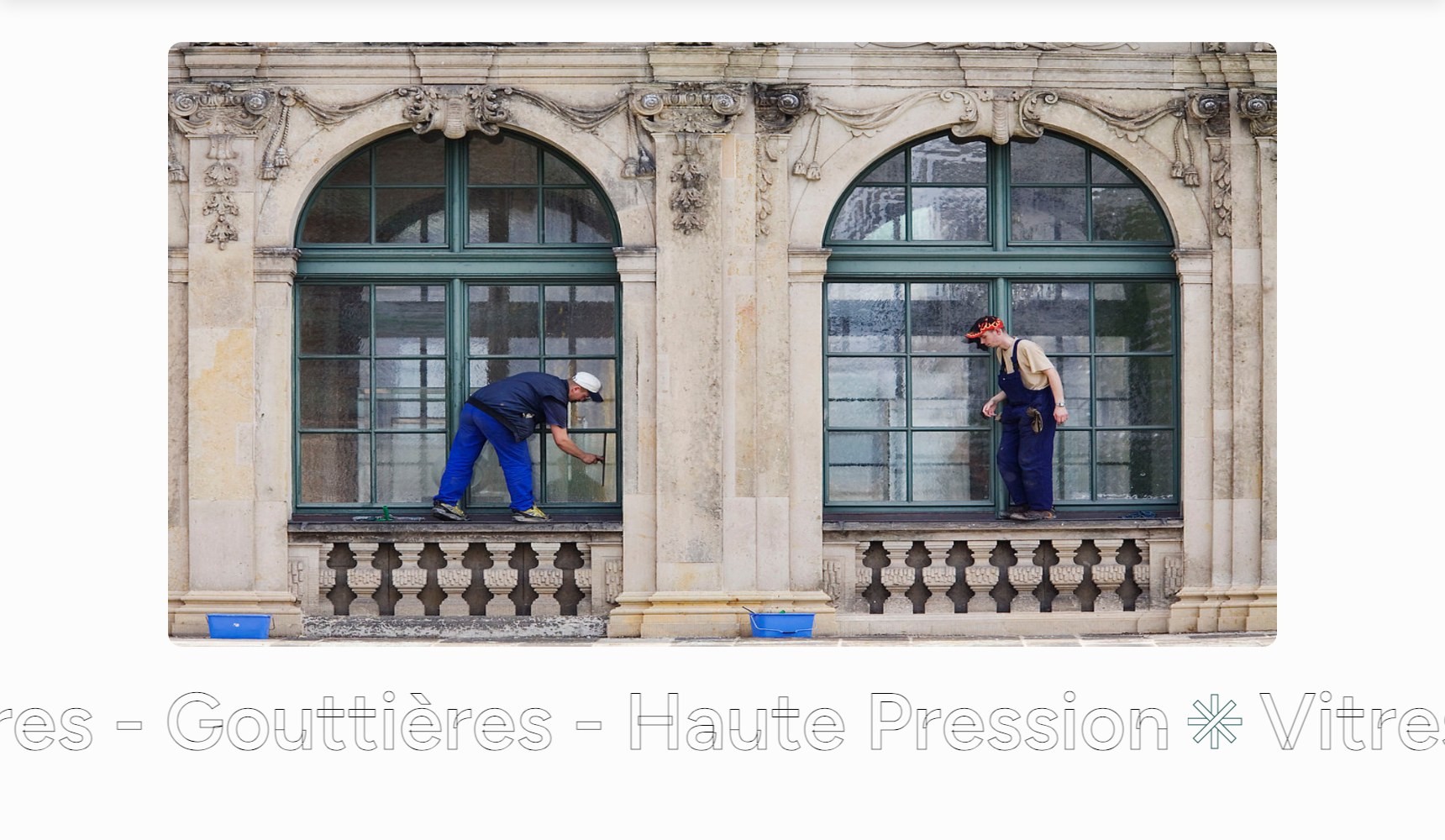 Wide photographic band of two technicians washing exterior windows