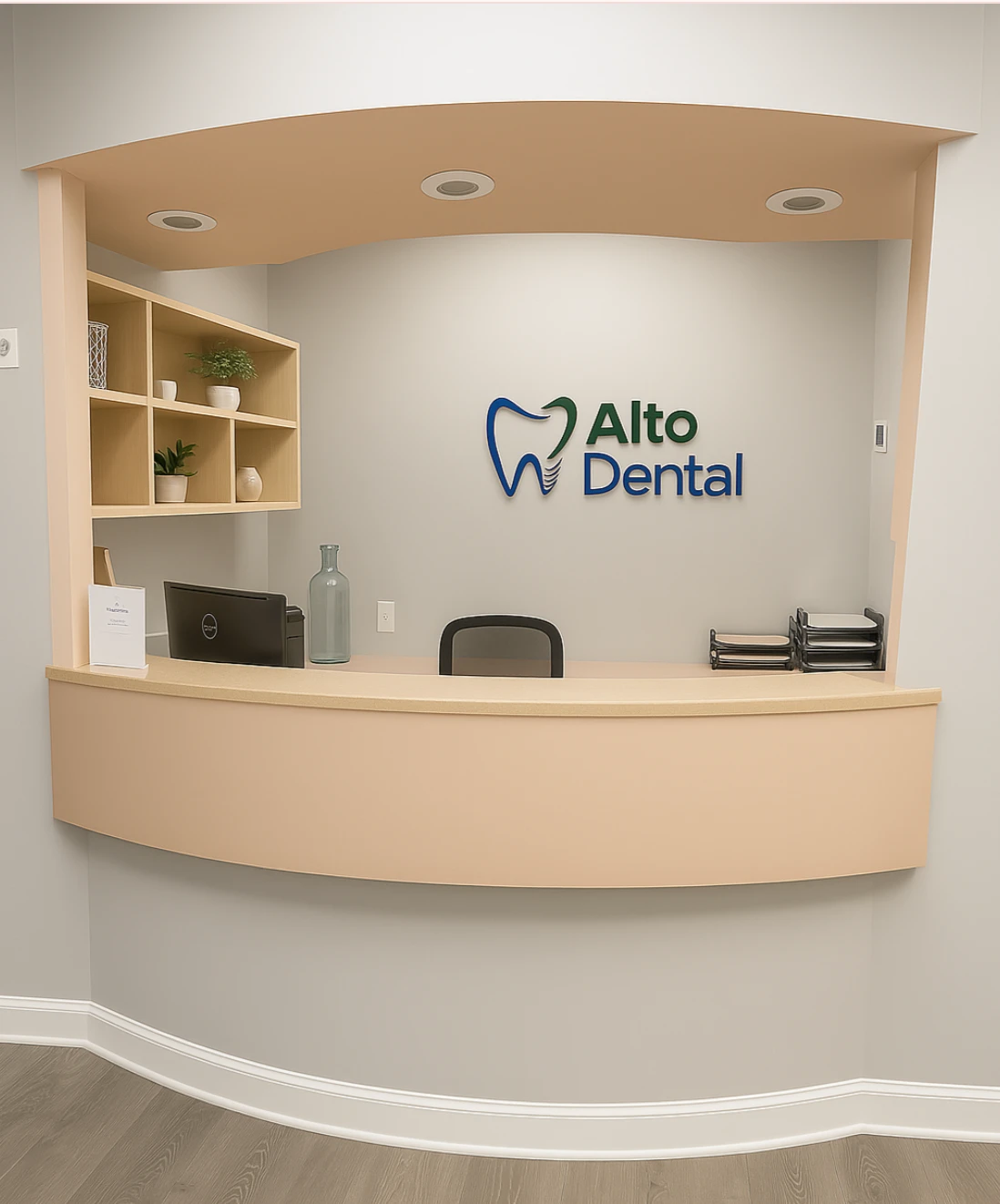 Reception desk with computer, plants, and Alto Dental logo on wall in a dental office.
