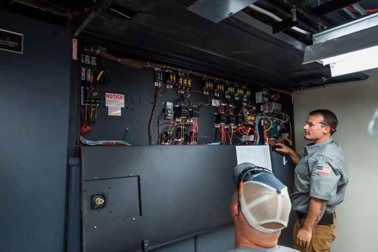 Mallory & Evans technicians inspecting an electrical control panel